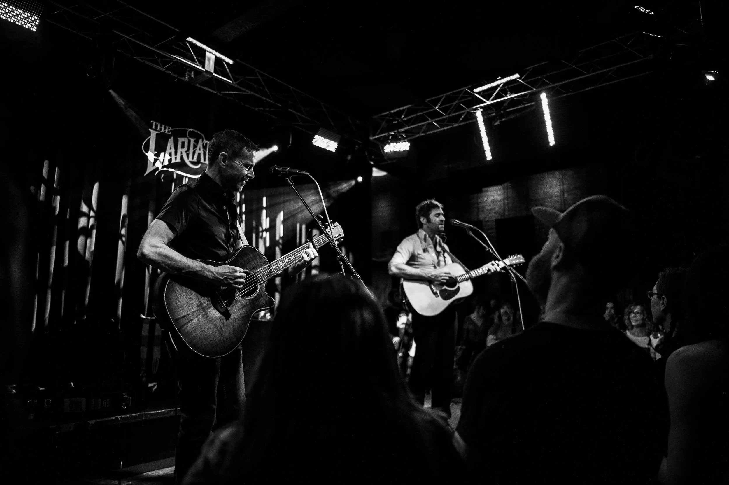 John Craigie playing guitar on stage during a live show in Buena Vista, Colorado.