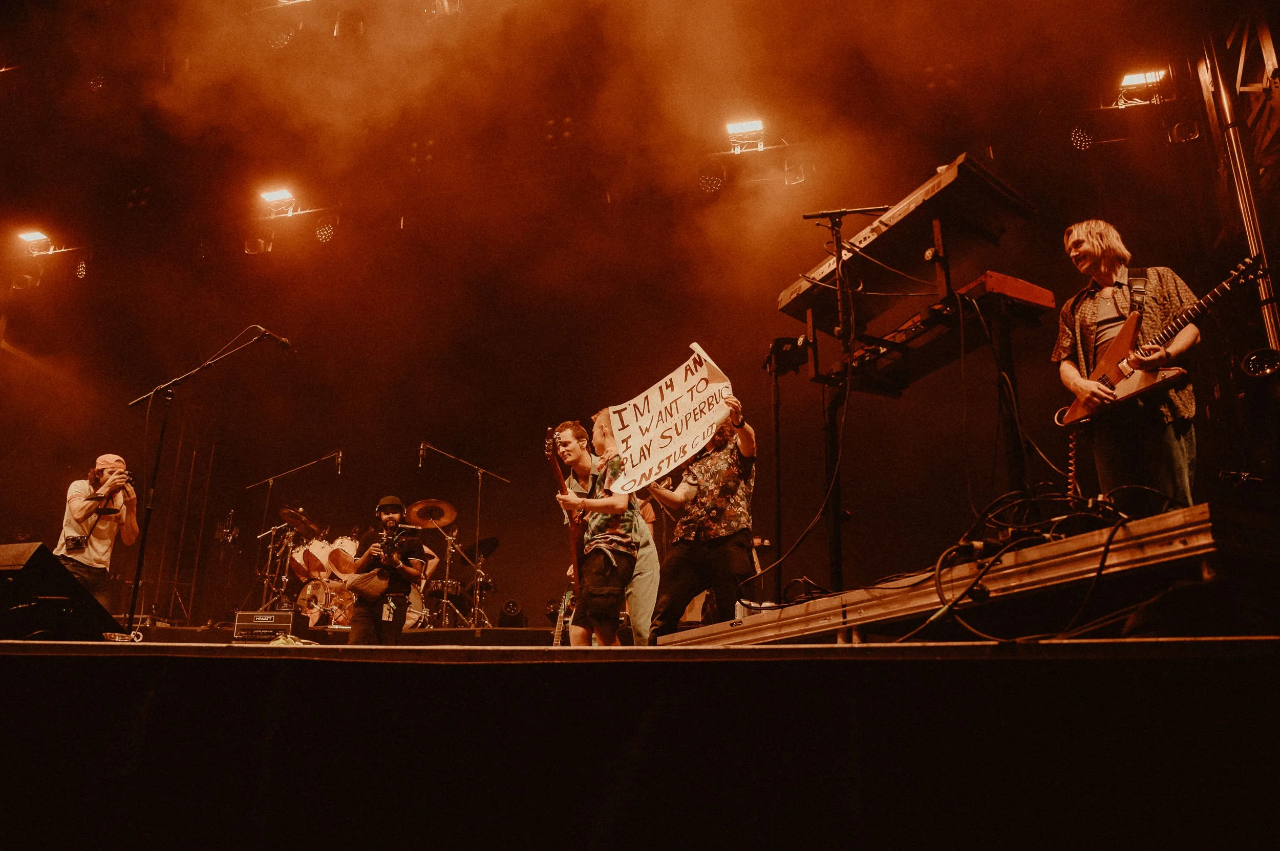 14-year-old Callum playing guitar on stage with King Gizzard during Superbug.