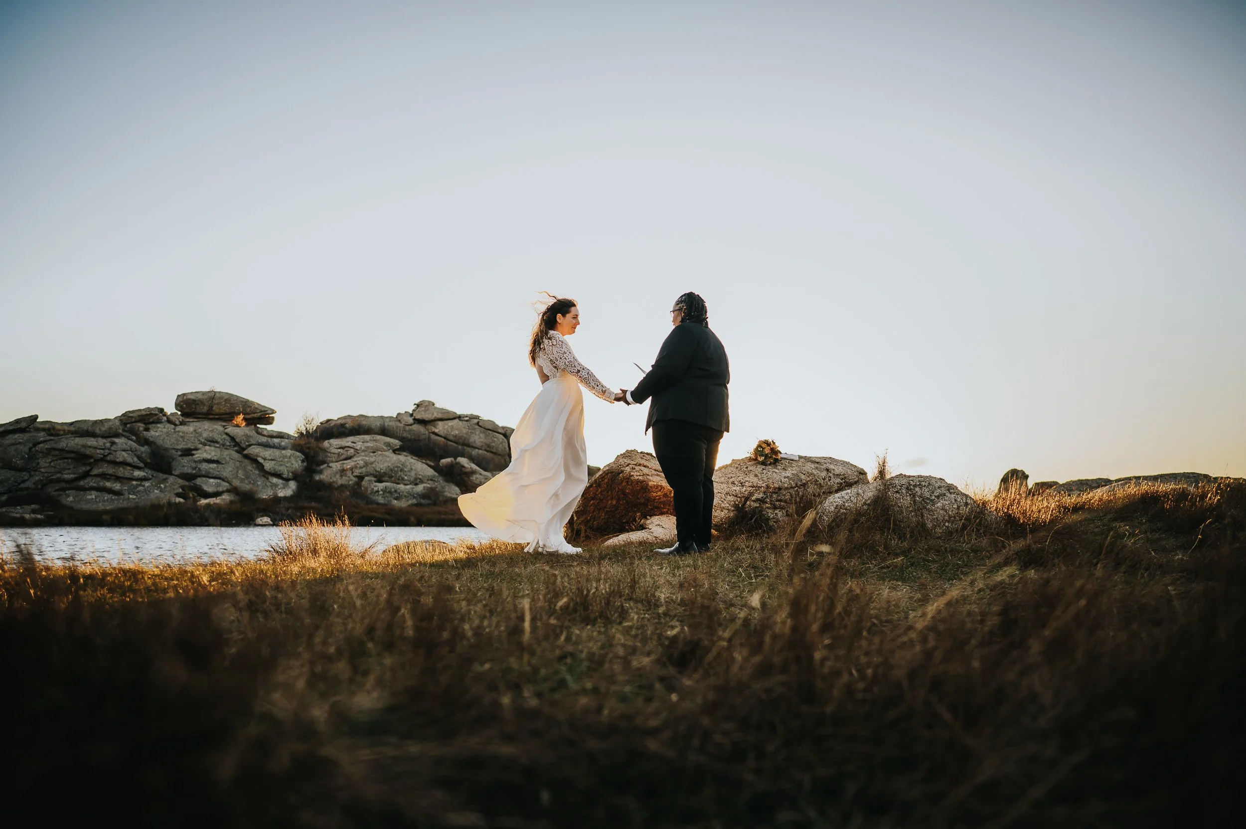 Married couple holding hands in the mountains near Lake George, Colorado.