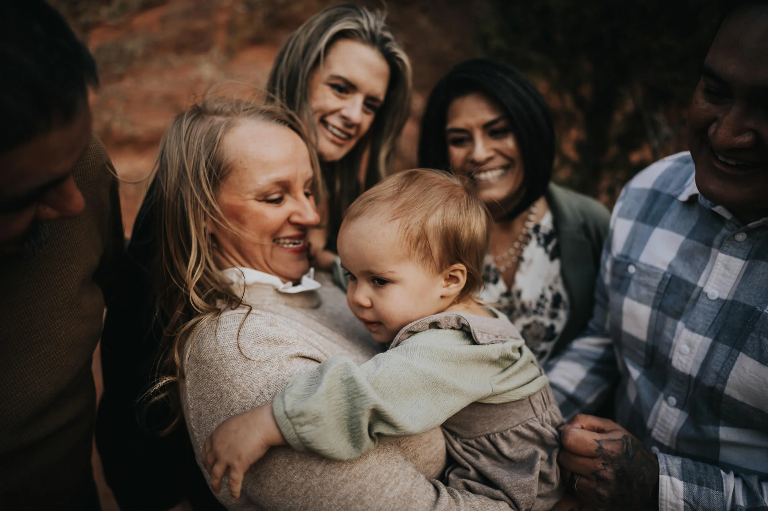 Grandparents sharing a joyful moment with their granddaughter during an extended family session.