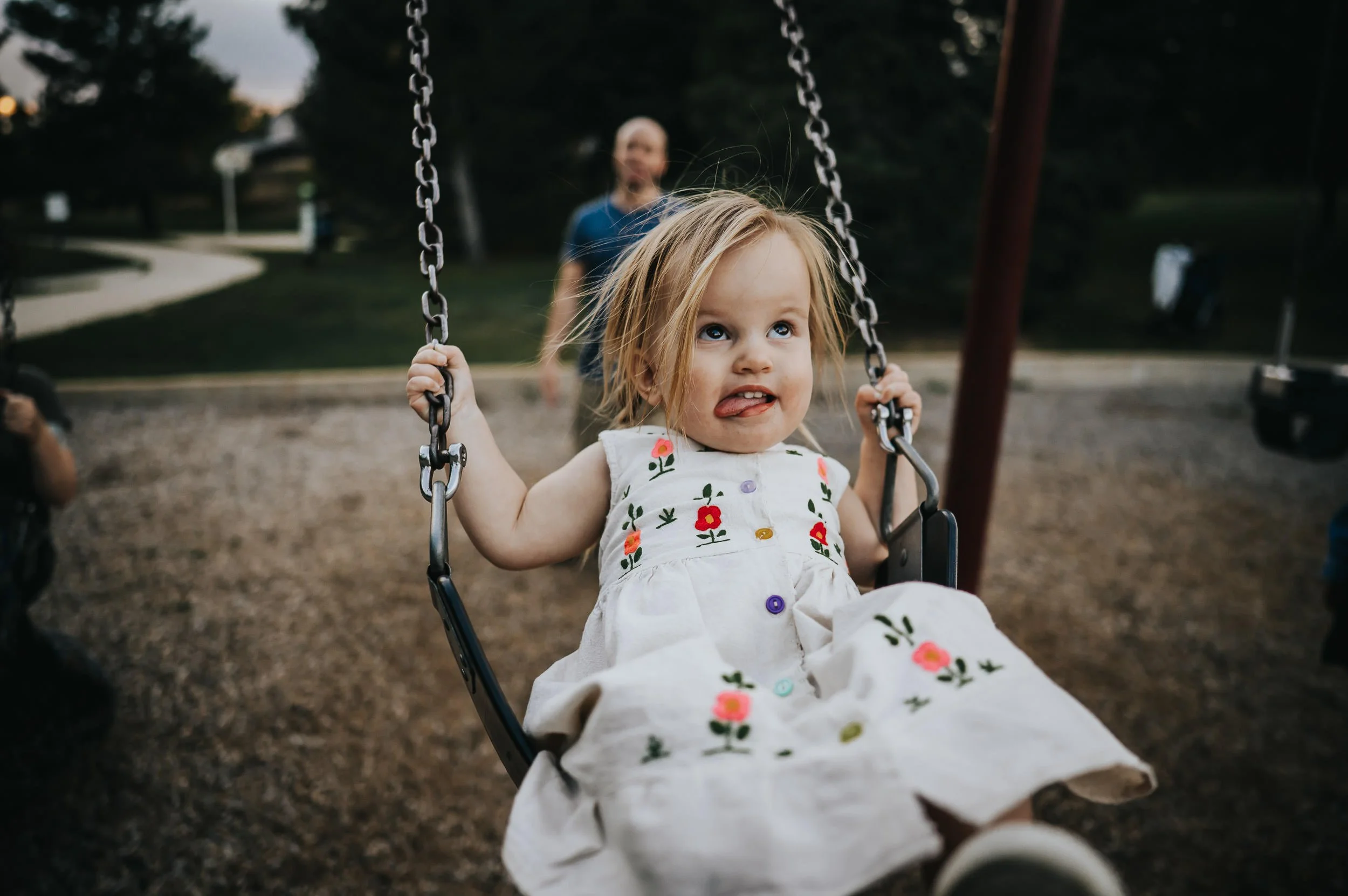 Toddler laughing freely during a playful family photography session in Denver.