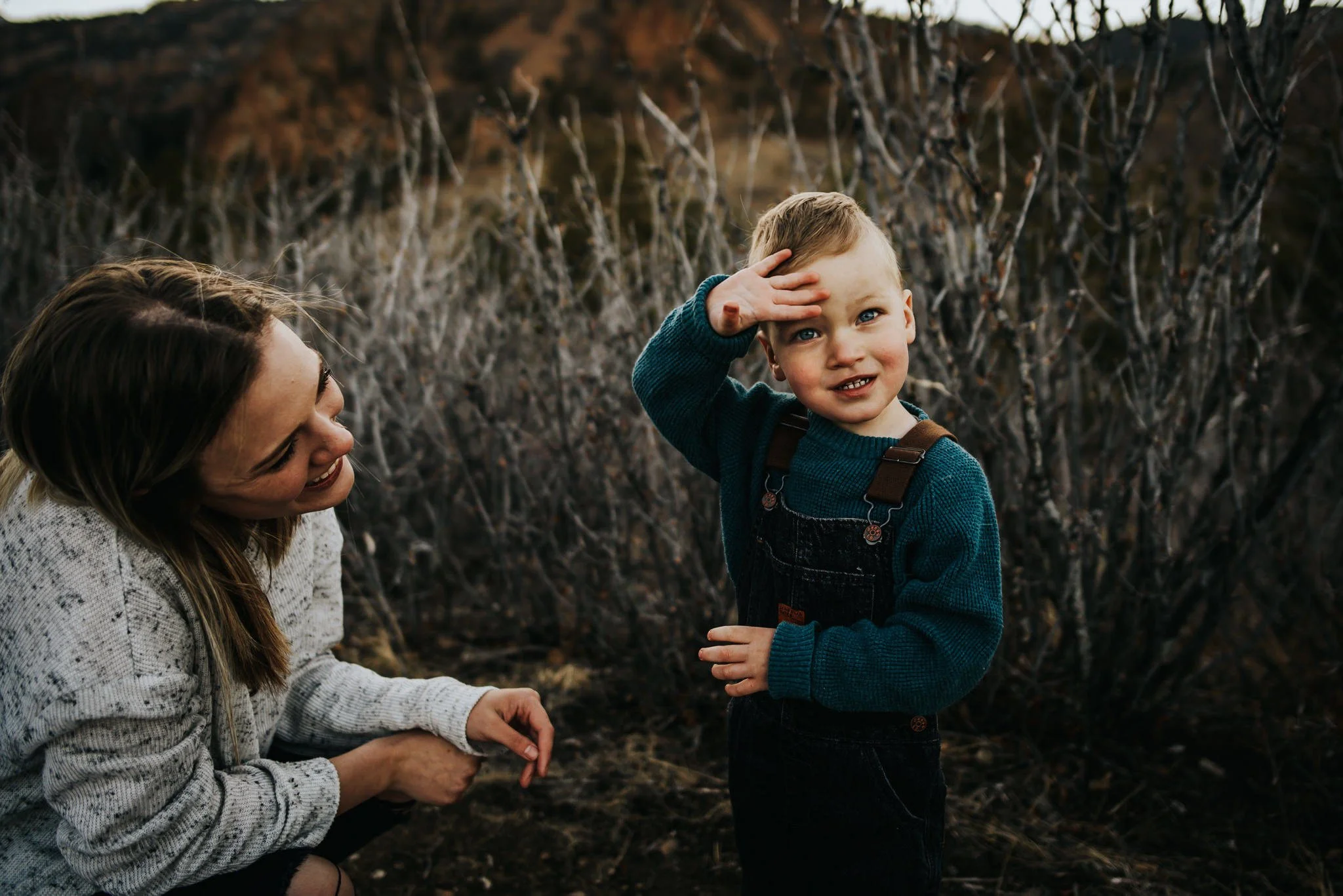 Mother and young son sharing a quiet moment during an outdoor family session in Colorado Springs, capturing a fleeting season of childhood.