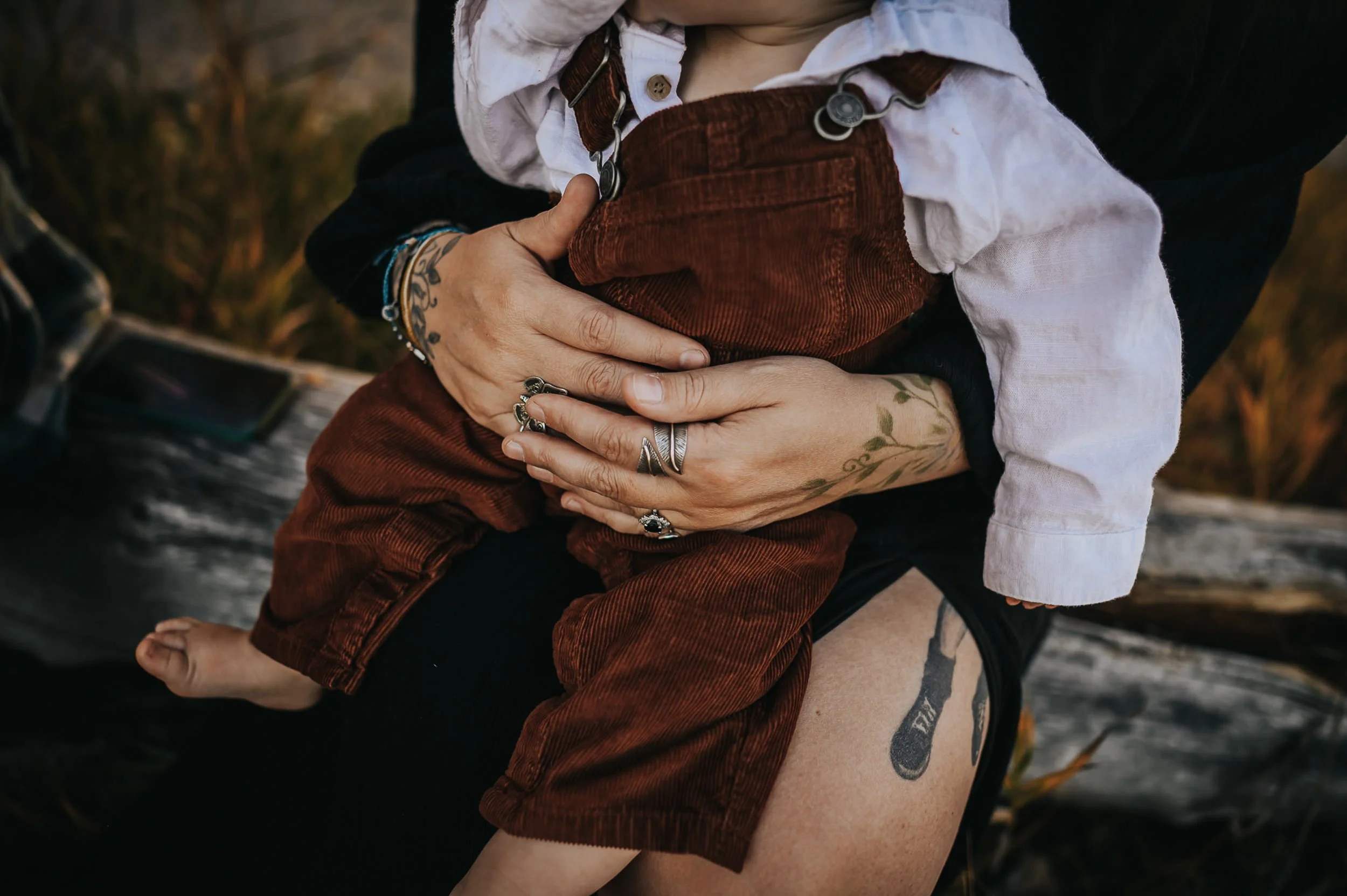 tattooed-mom-holding-son-barefoot.jpg