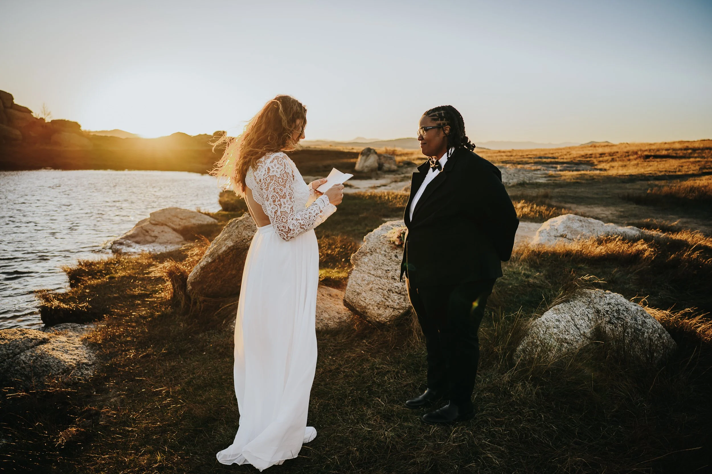 Two women exchanging vows during their self-solemnizing elopement ceremony in Colorado.