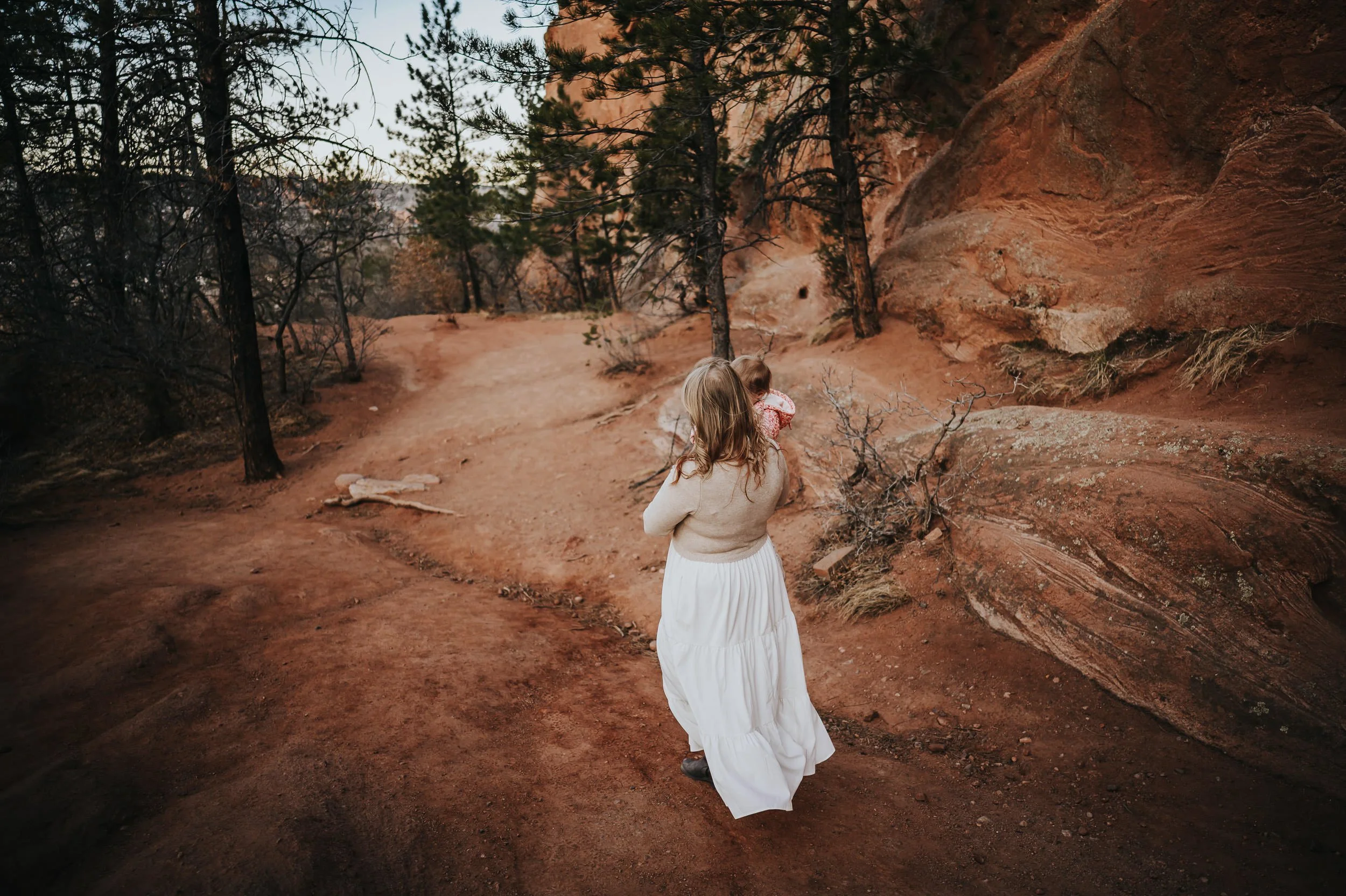 Toddler exploring trails with family during a natural family photography session in Colorado Springs.