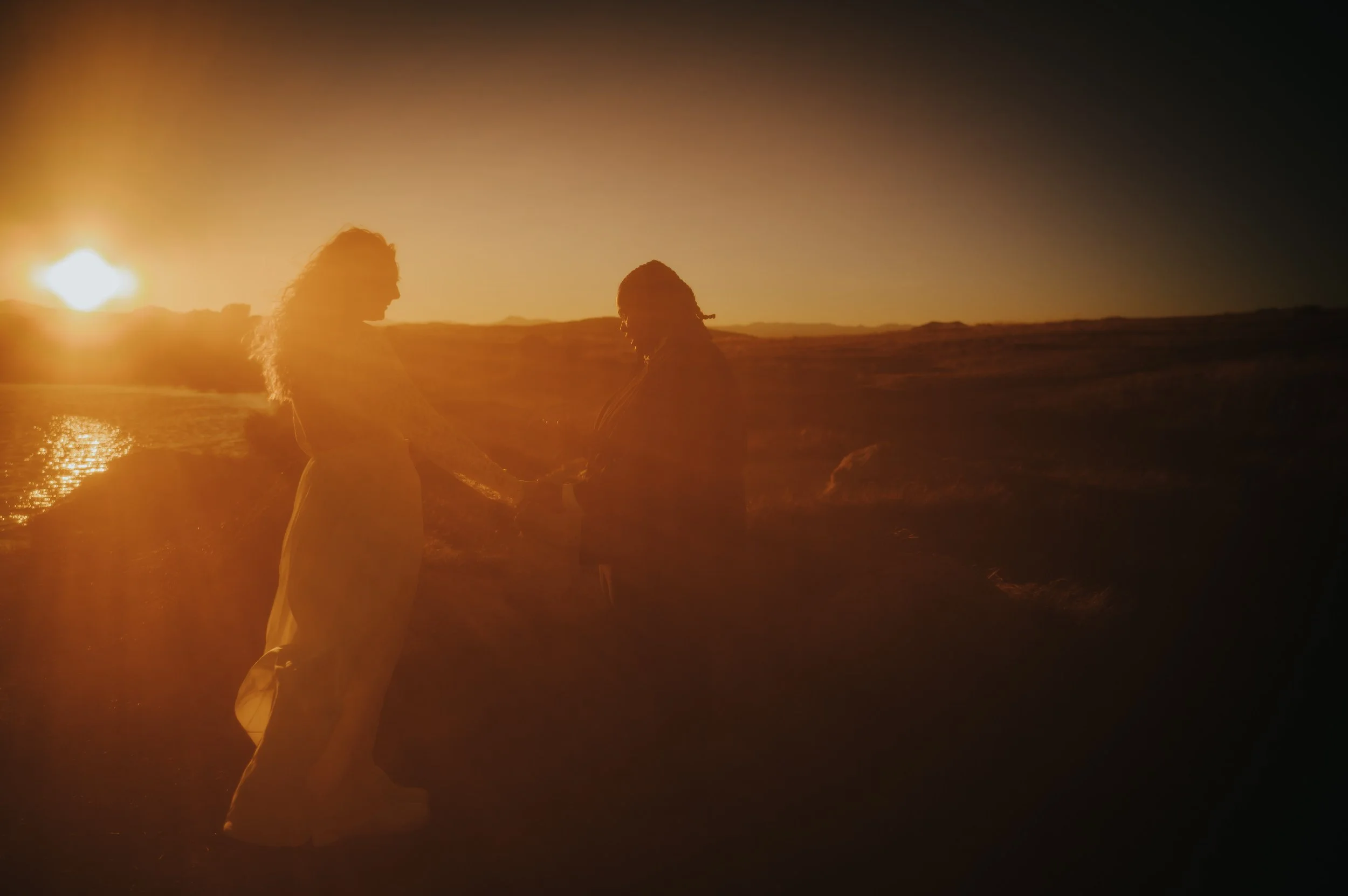 colorado-mountains.jpgTwo brides holding hands during their self-solemnizing ceremony with mountains in the distance.