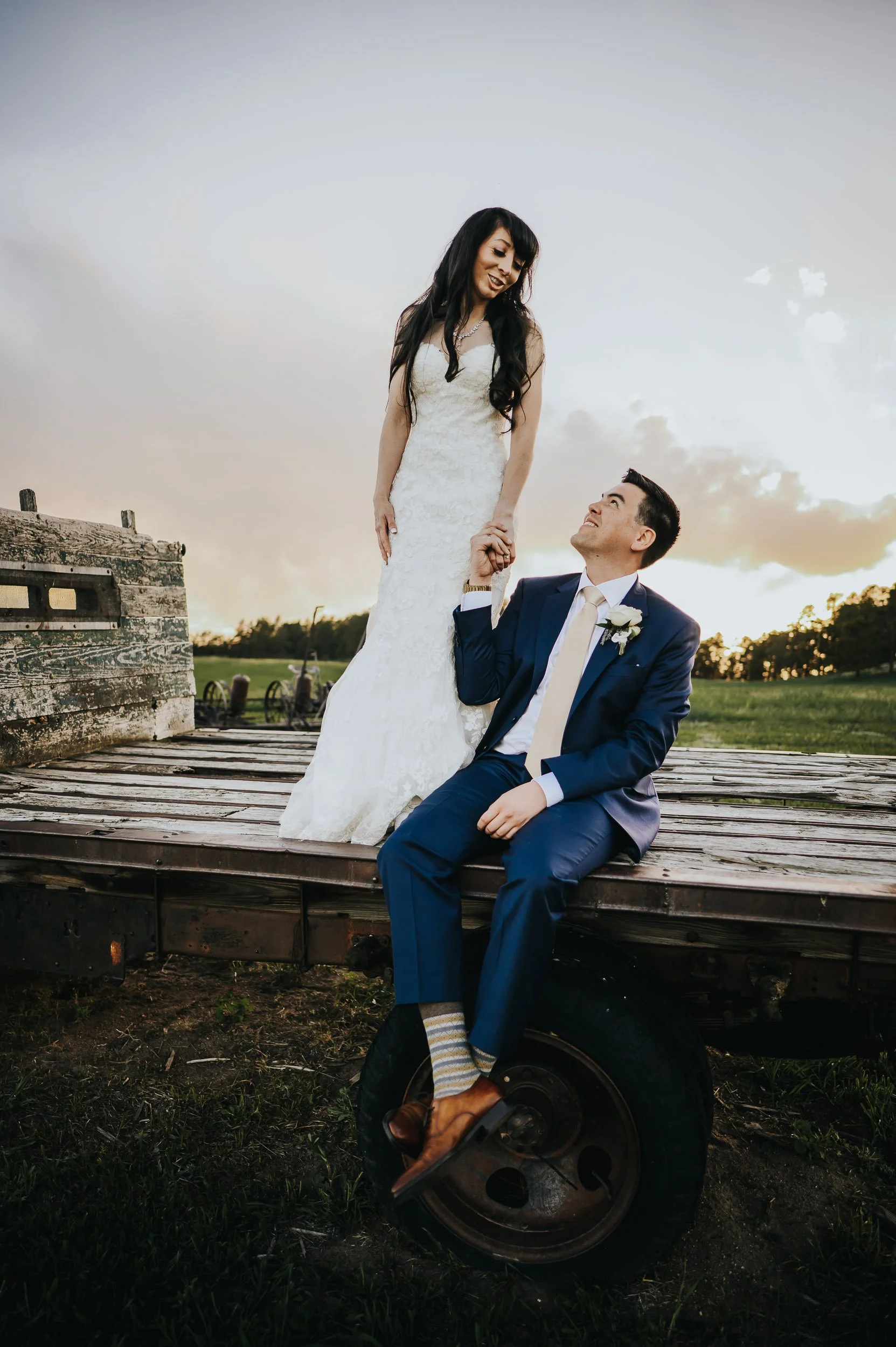 Golden hour wedding portraits at Younger Ranch with warm light and mountain scenery.