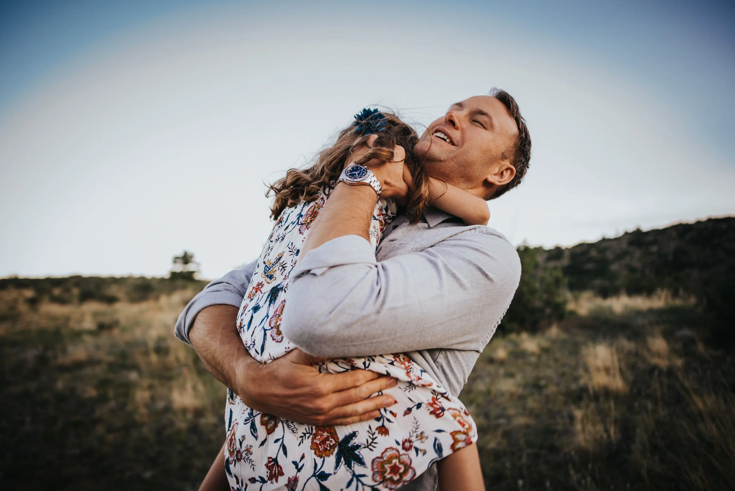 father-daughter-laughing-embrace-colorado-field.jpg