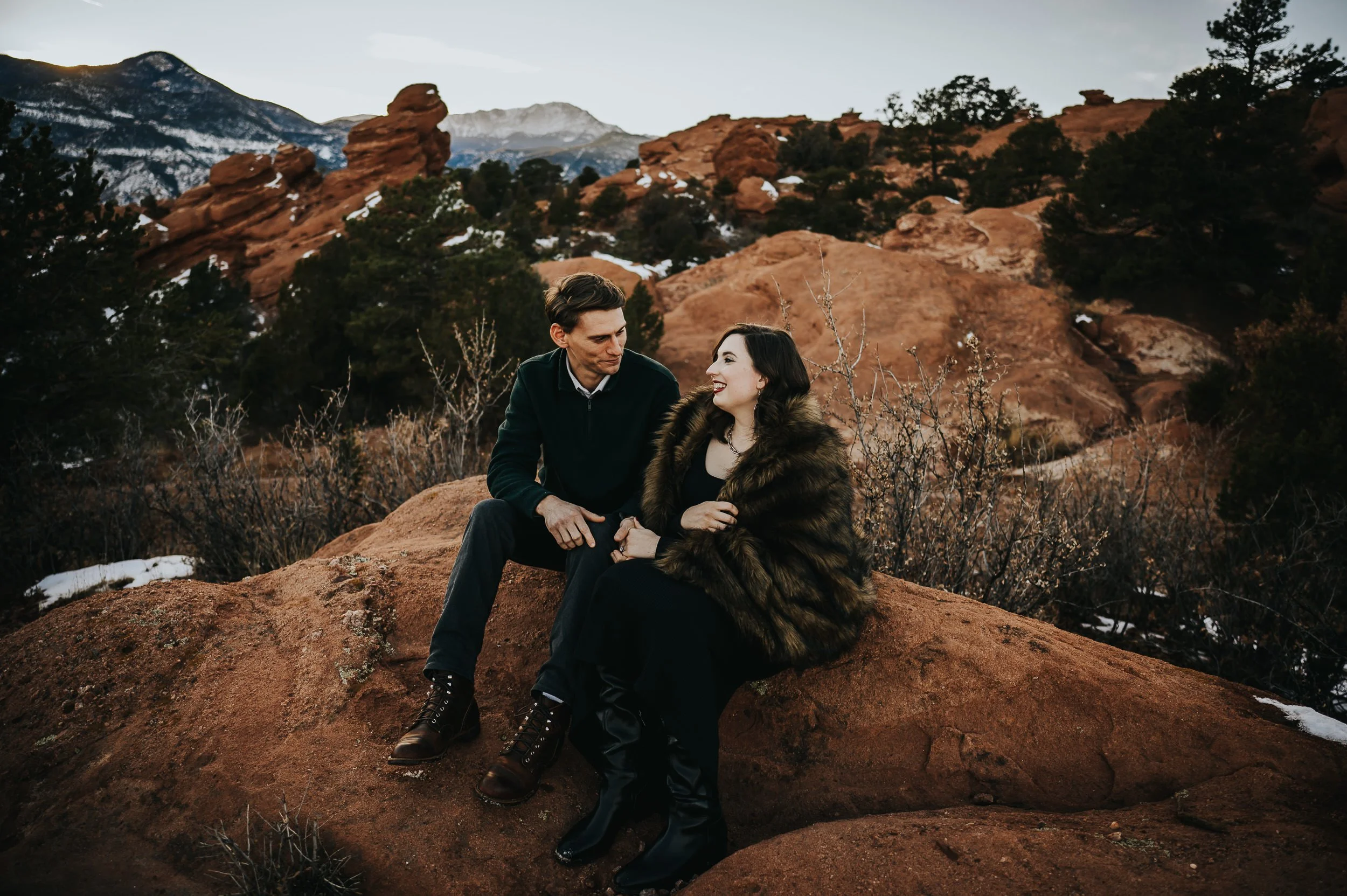 Pregnant woman in intentional color palette during Garden of the Gods maternity session at sunset.