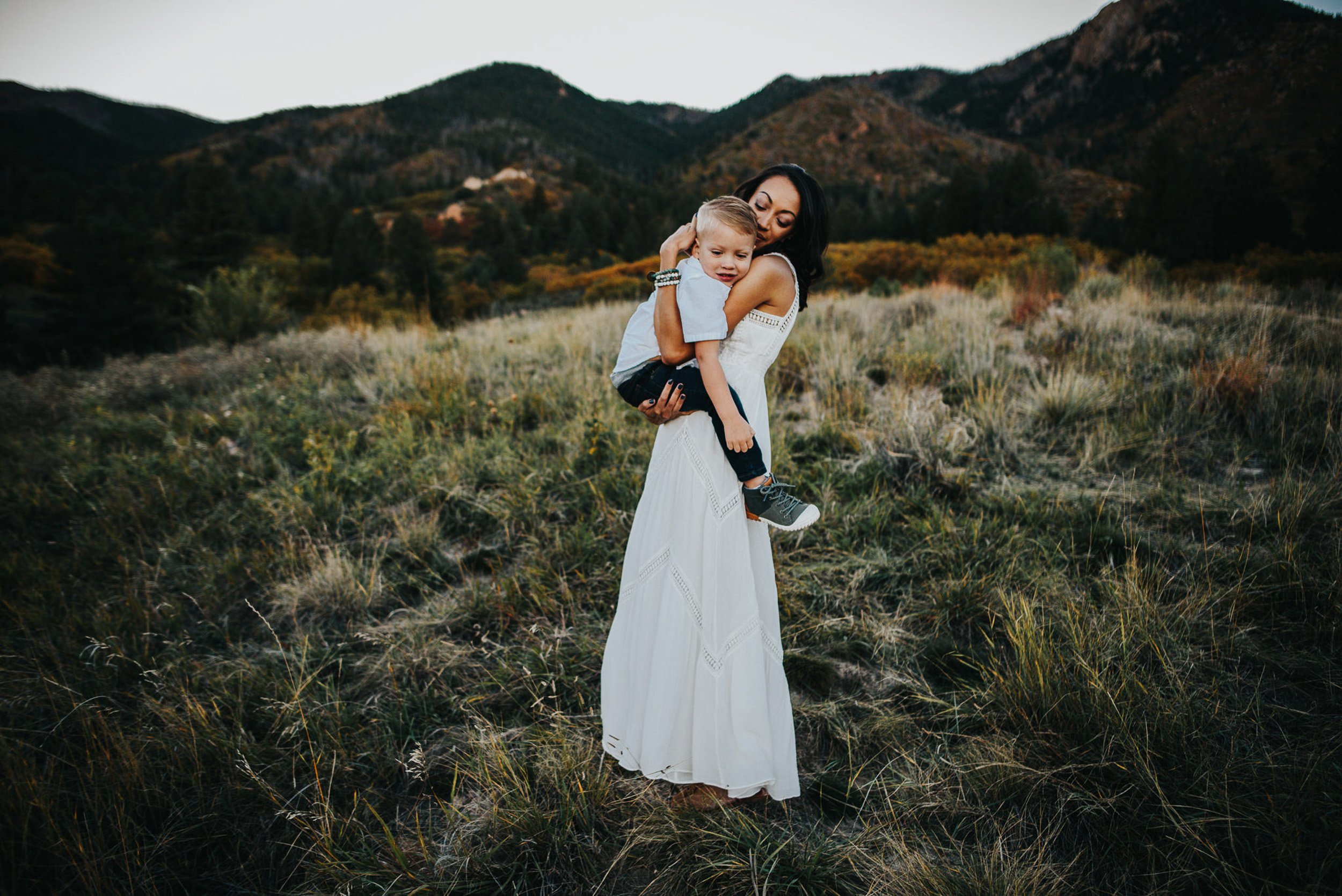 mom-holding-toddler-son-white-dress.jpg