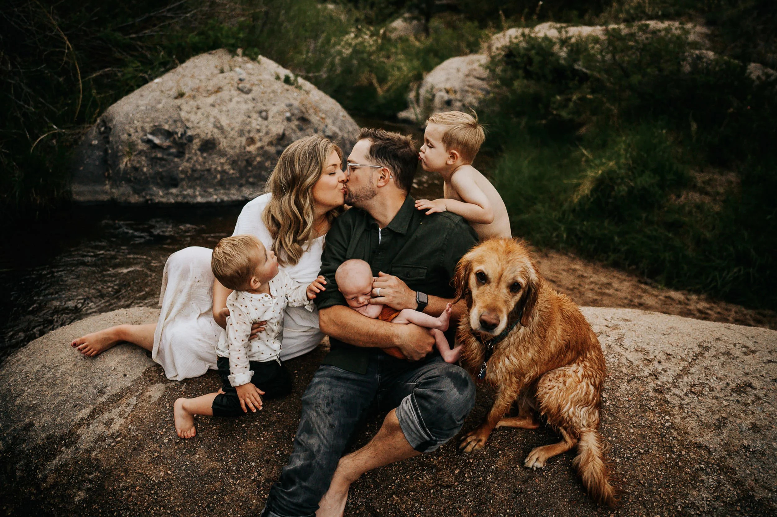 Family exploring the creek at Castlewood Canyon State Park during golden hour.