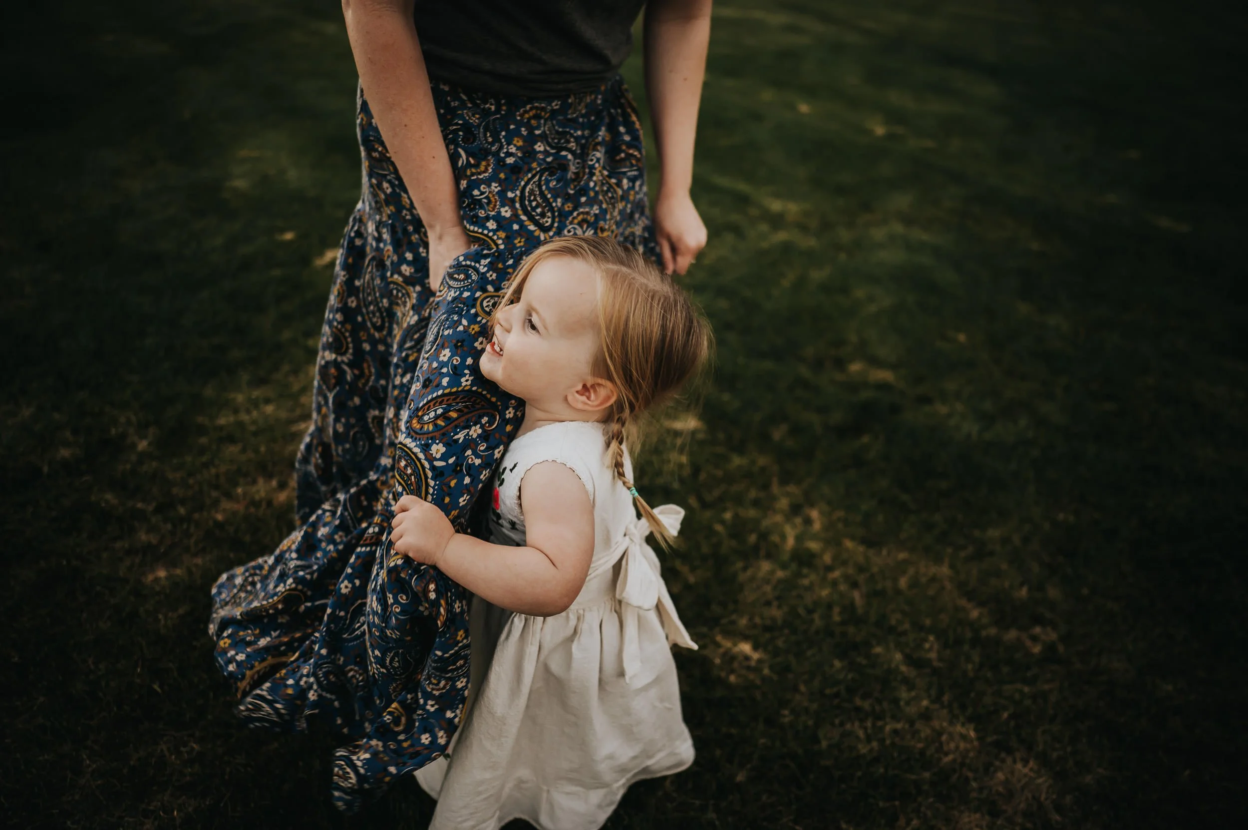 Mother and daughter sharing a quiet moment during a family session in a Denver park.