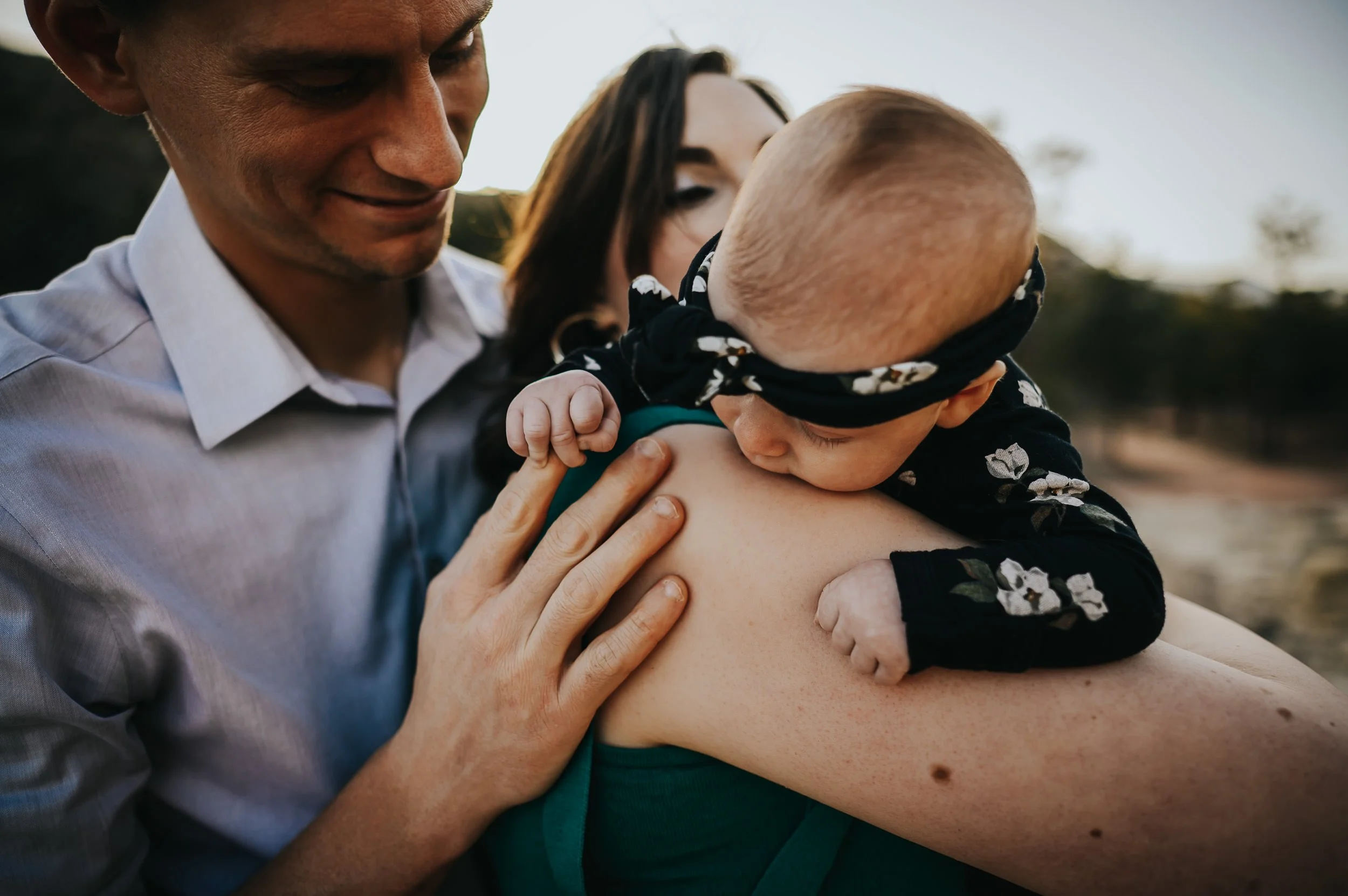Parents holding baby during outdoor newborn session at Ute Valley Park in Colorado Springs.