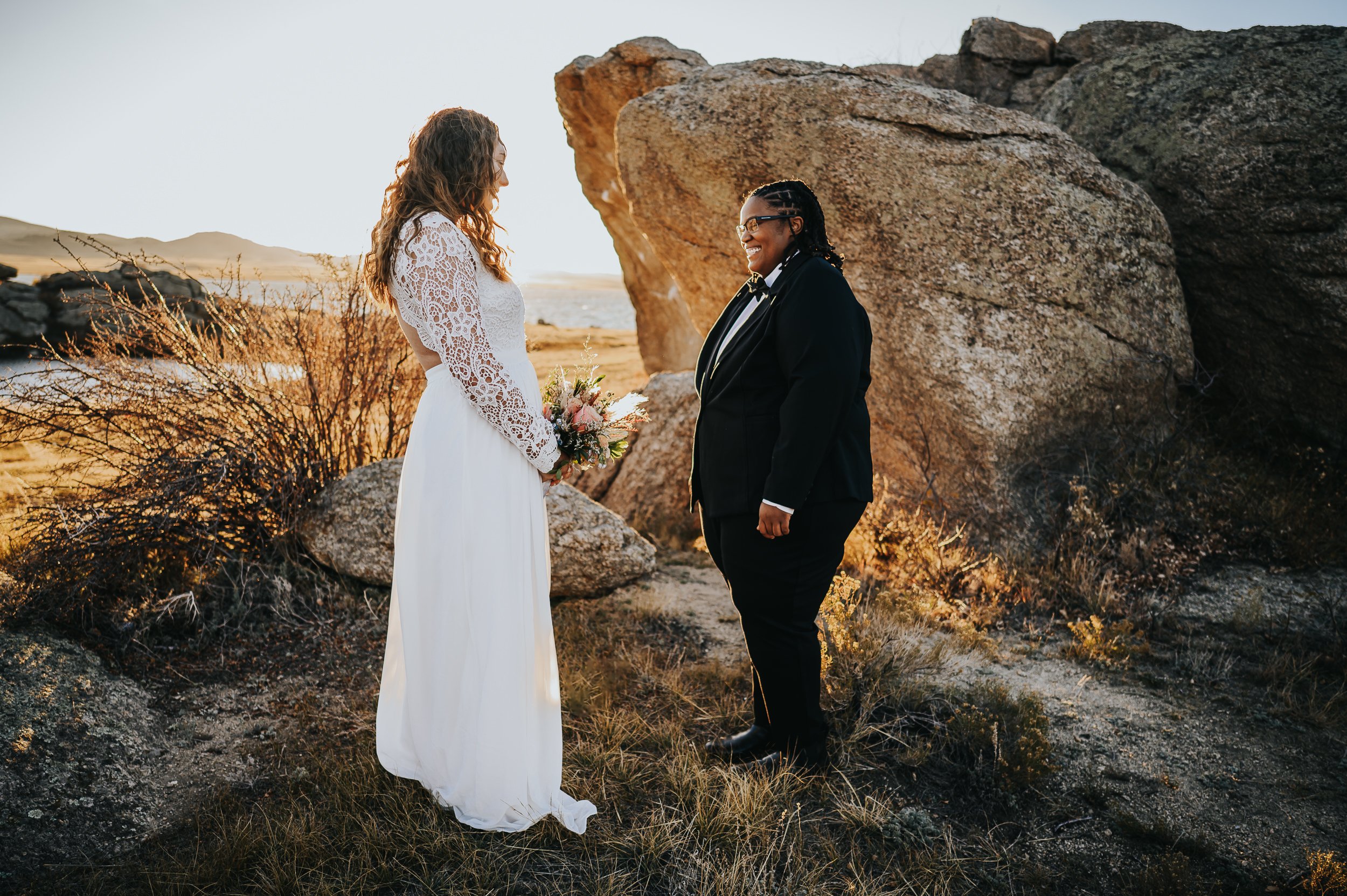Emotional first look between two brides at their Colorado mountain elopement.