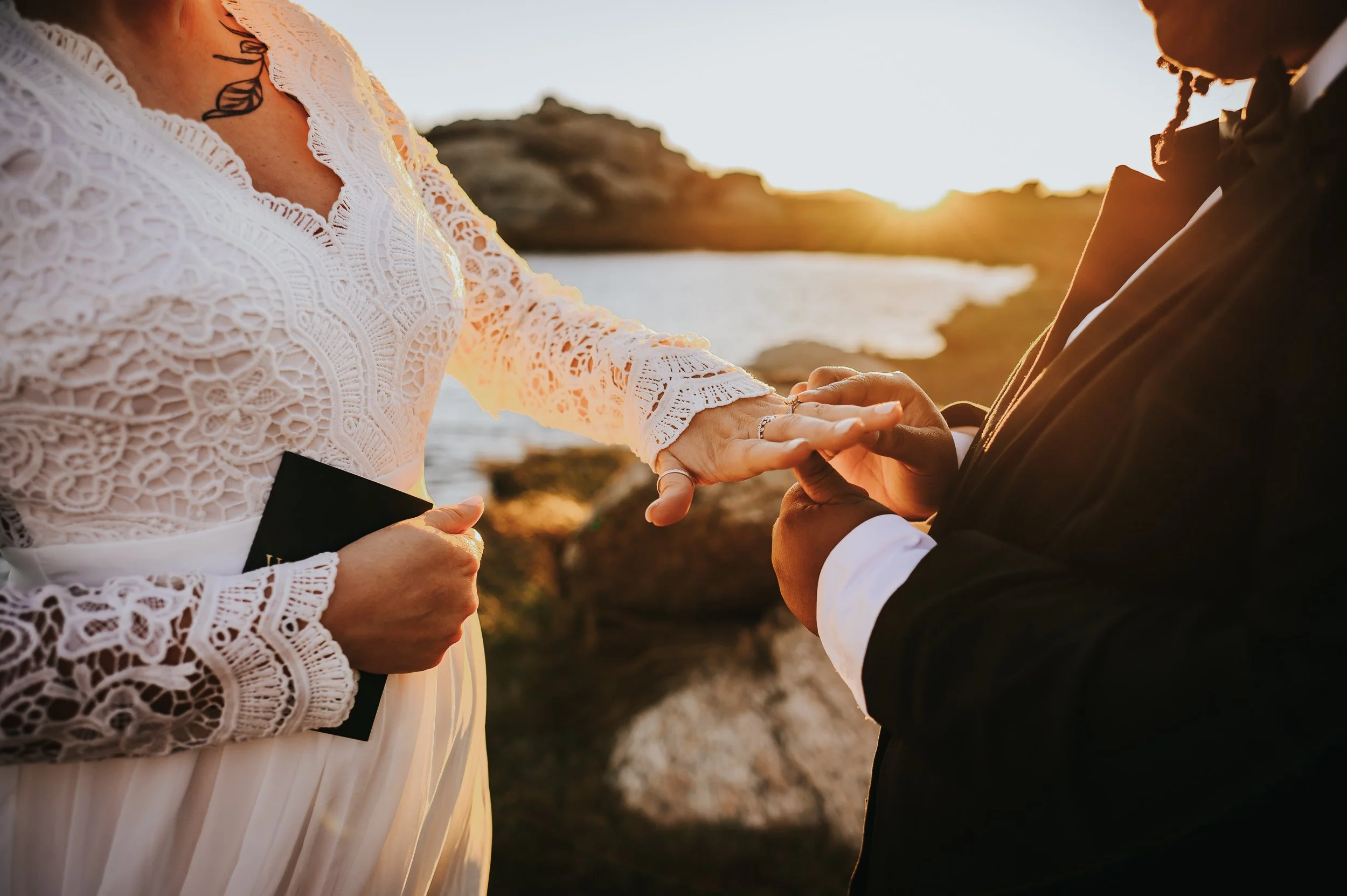Bride placing ring on her partner's finger during their Colorado elopement ceremony.