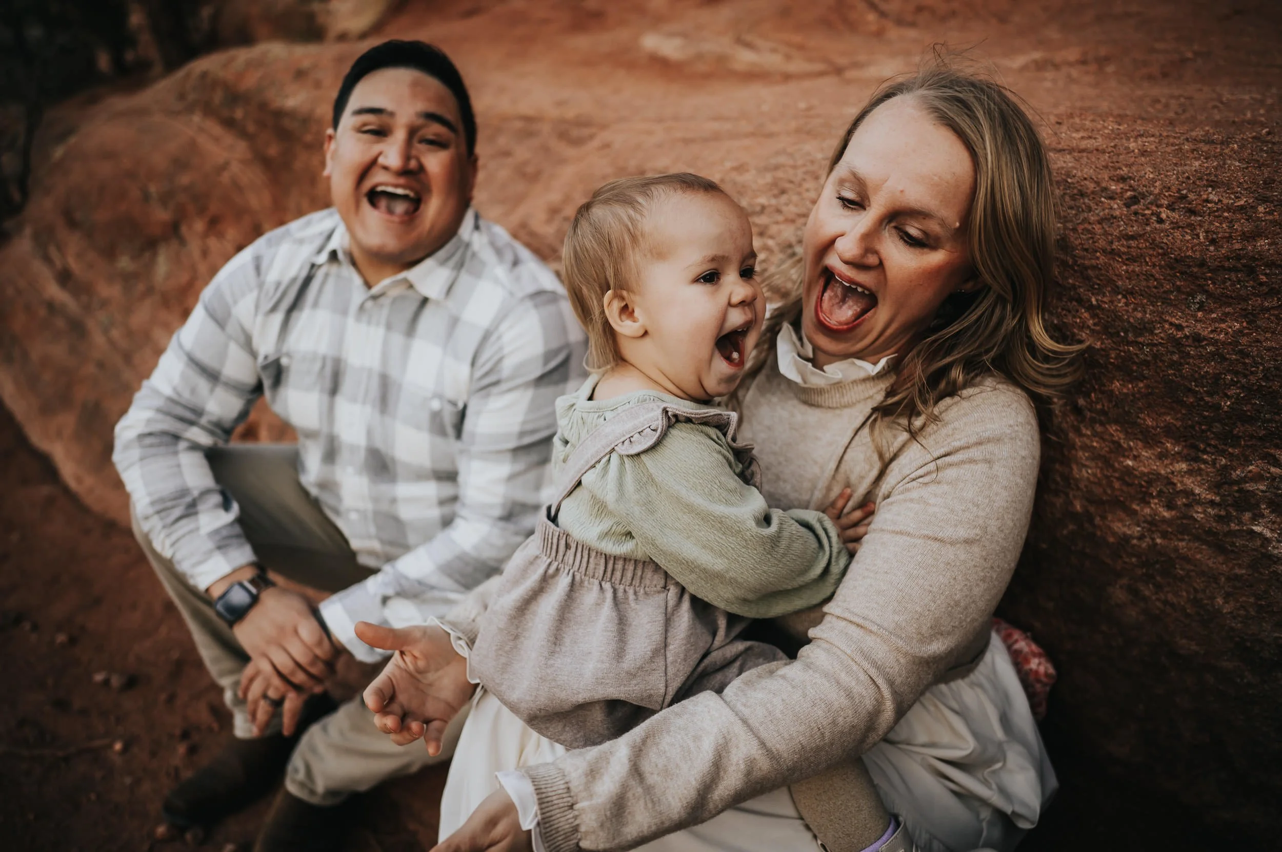 Candid laughter and movement during a golden hour family photography session at Red Rock Canyon.