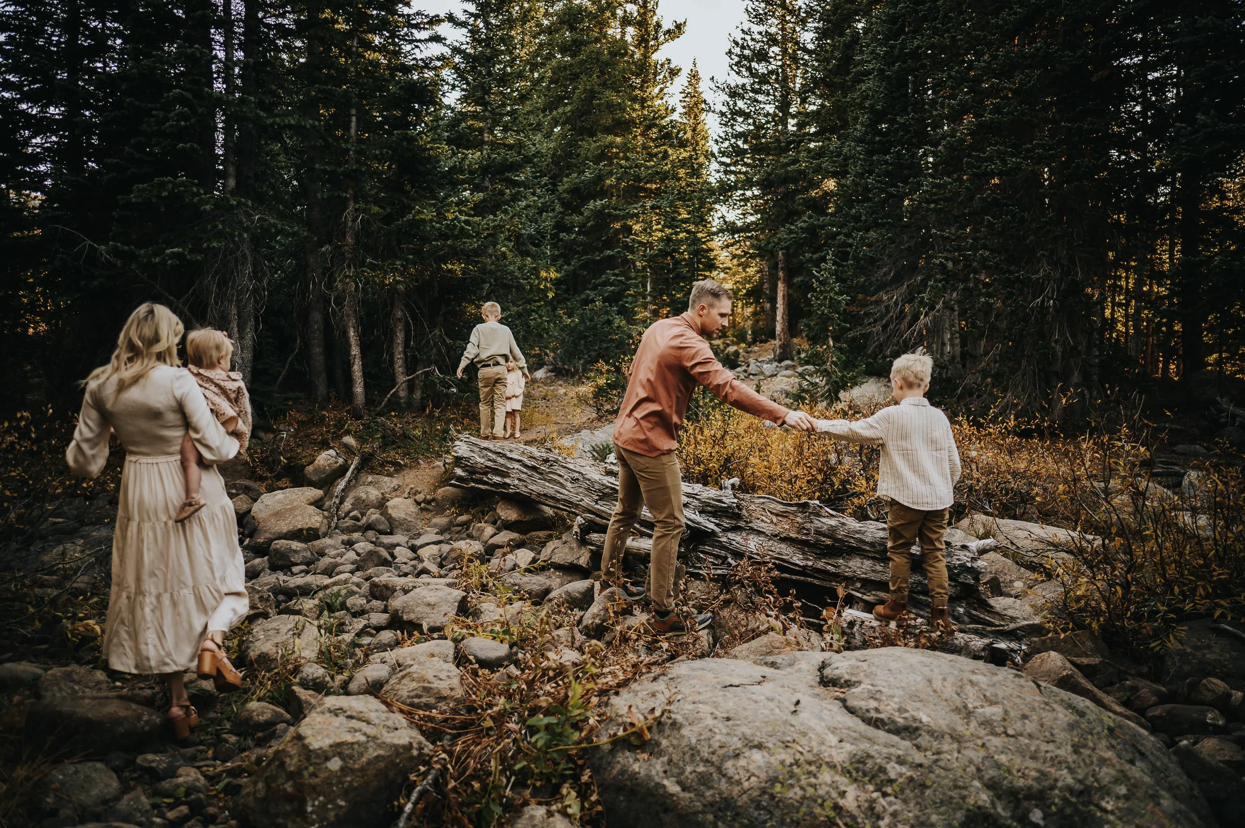 Father holding his child with mountain views during a family photo session at Brainard Lake.