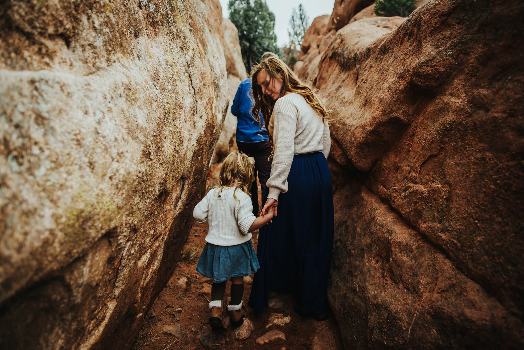 Family at Red Rock Canyon Open Space with red rock formations glowing at sunset.