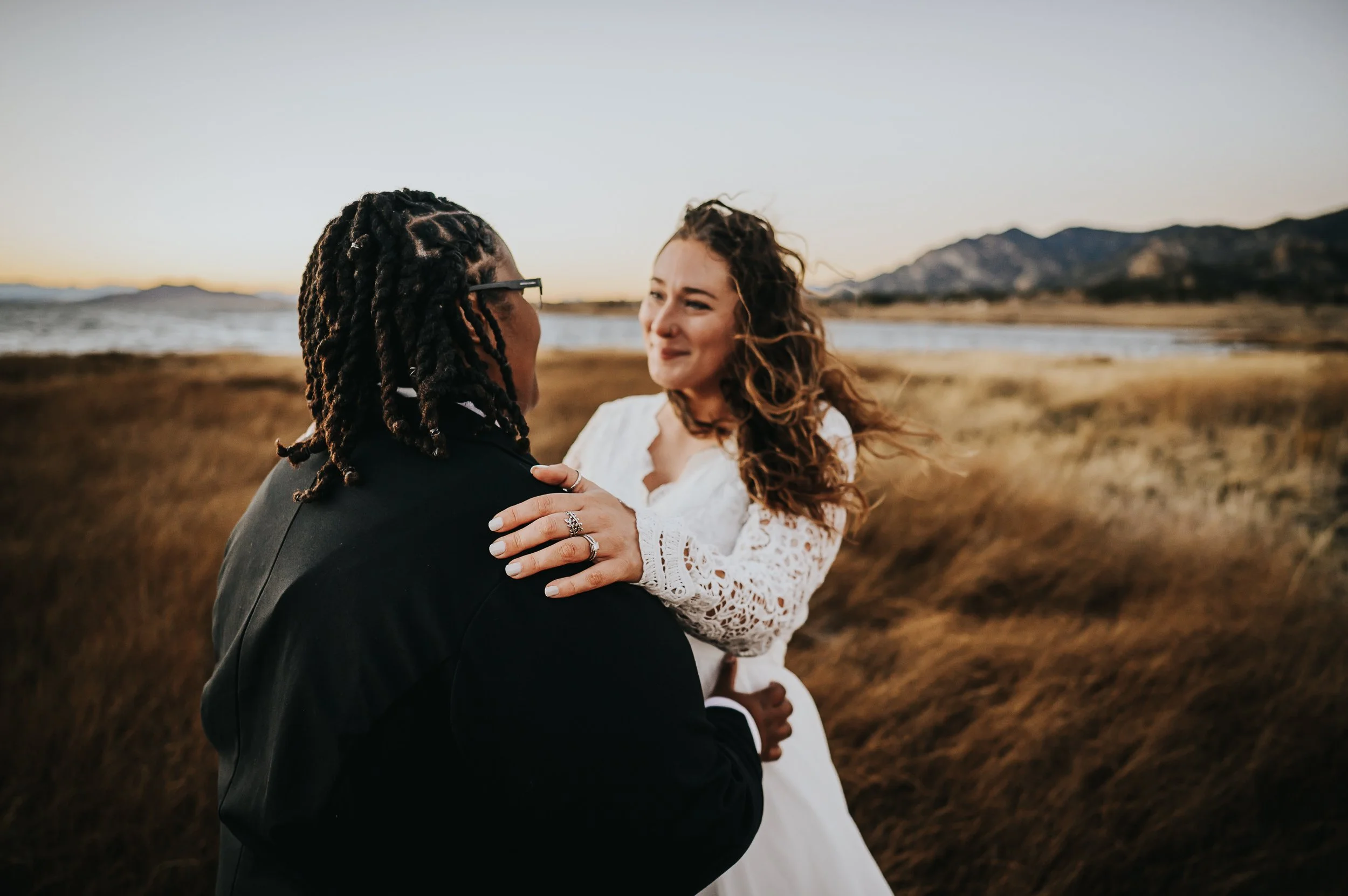Two brides exploring the mountain landscape after their intimate elopement.
