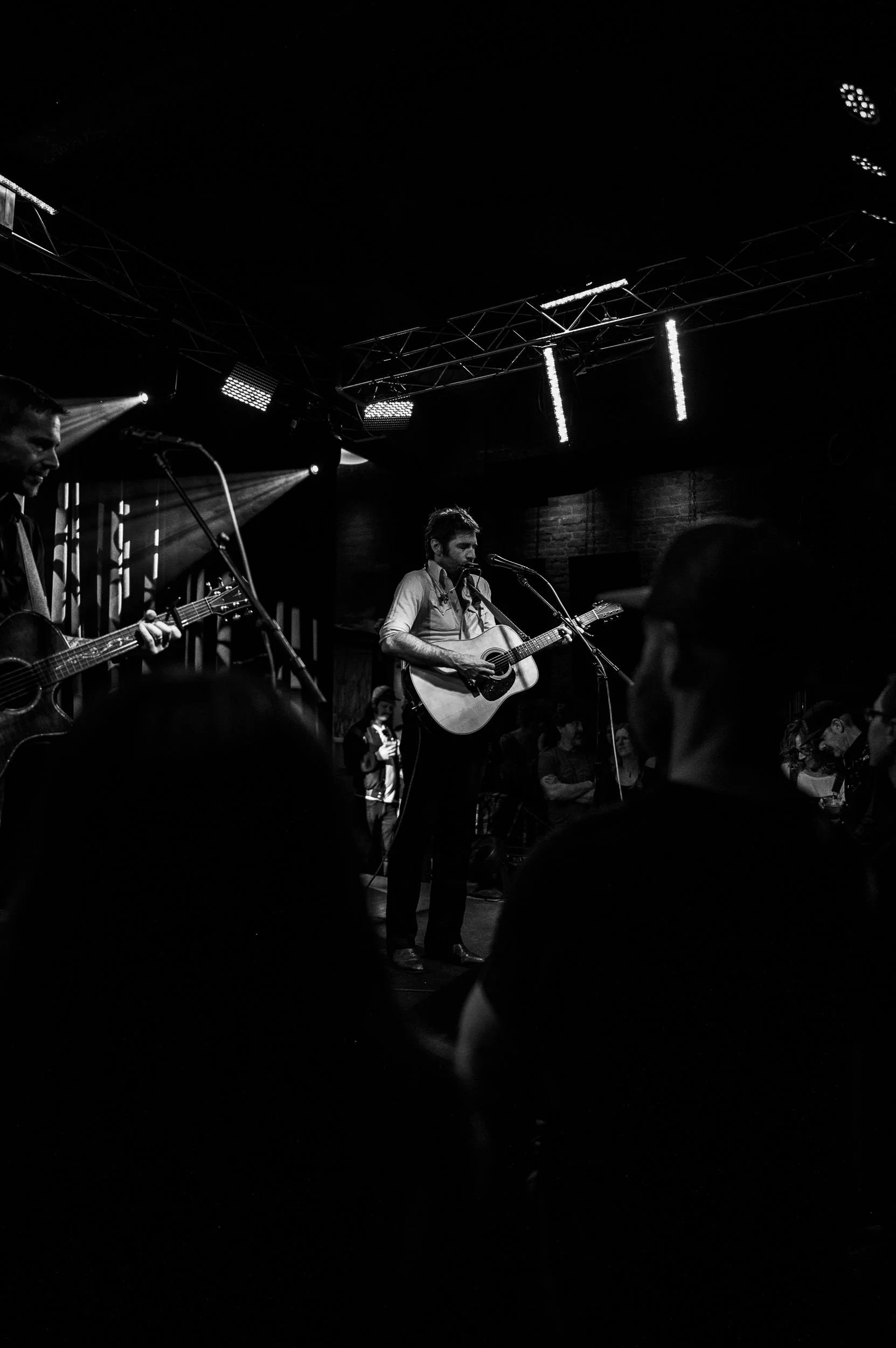 John Craigie performing live for a packed crowd at The Lariat in Buena Vista.