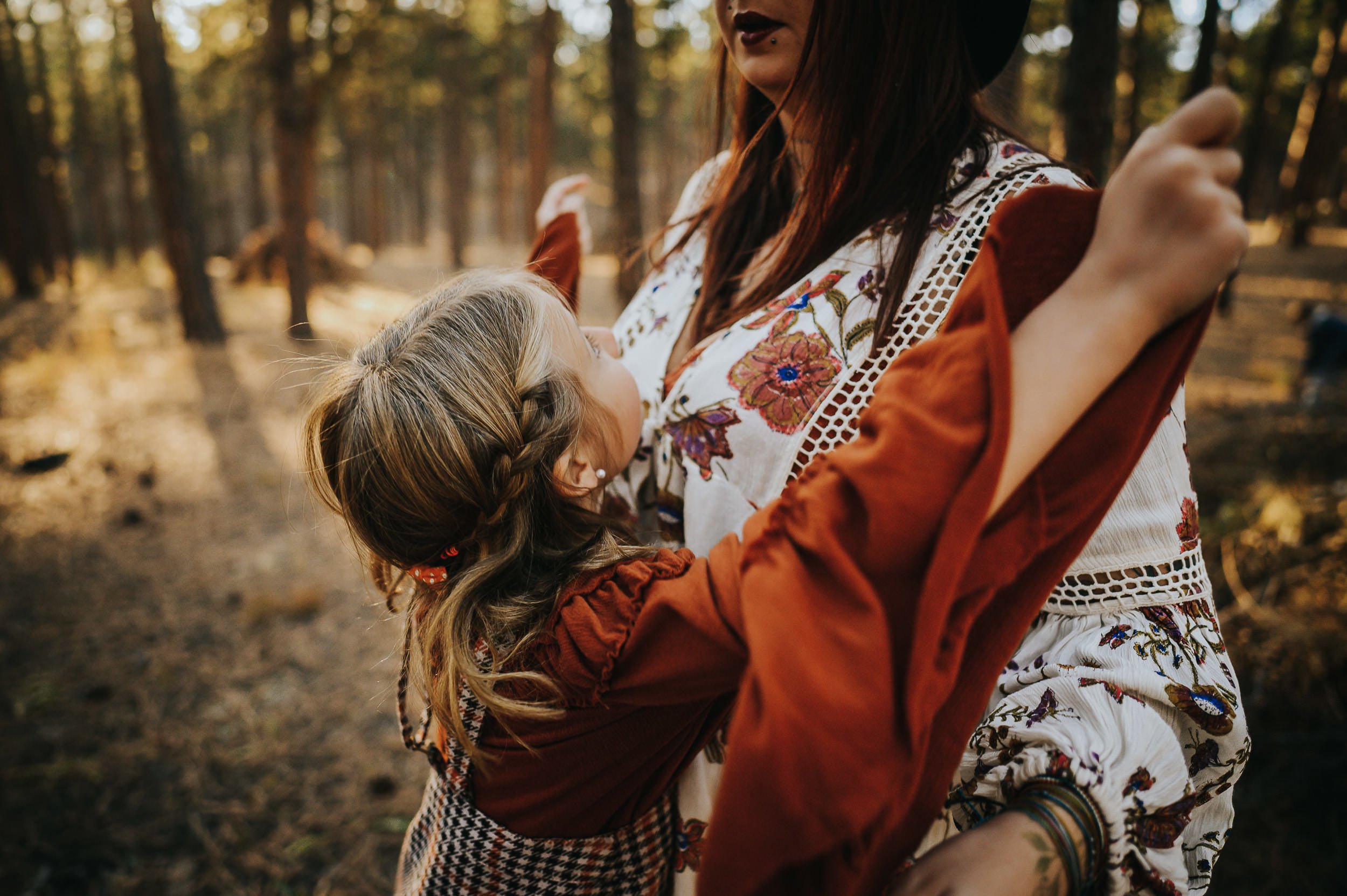 daughter-red-dress-wings-hugging-mom.jpg
