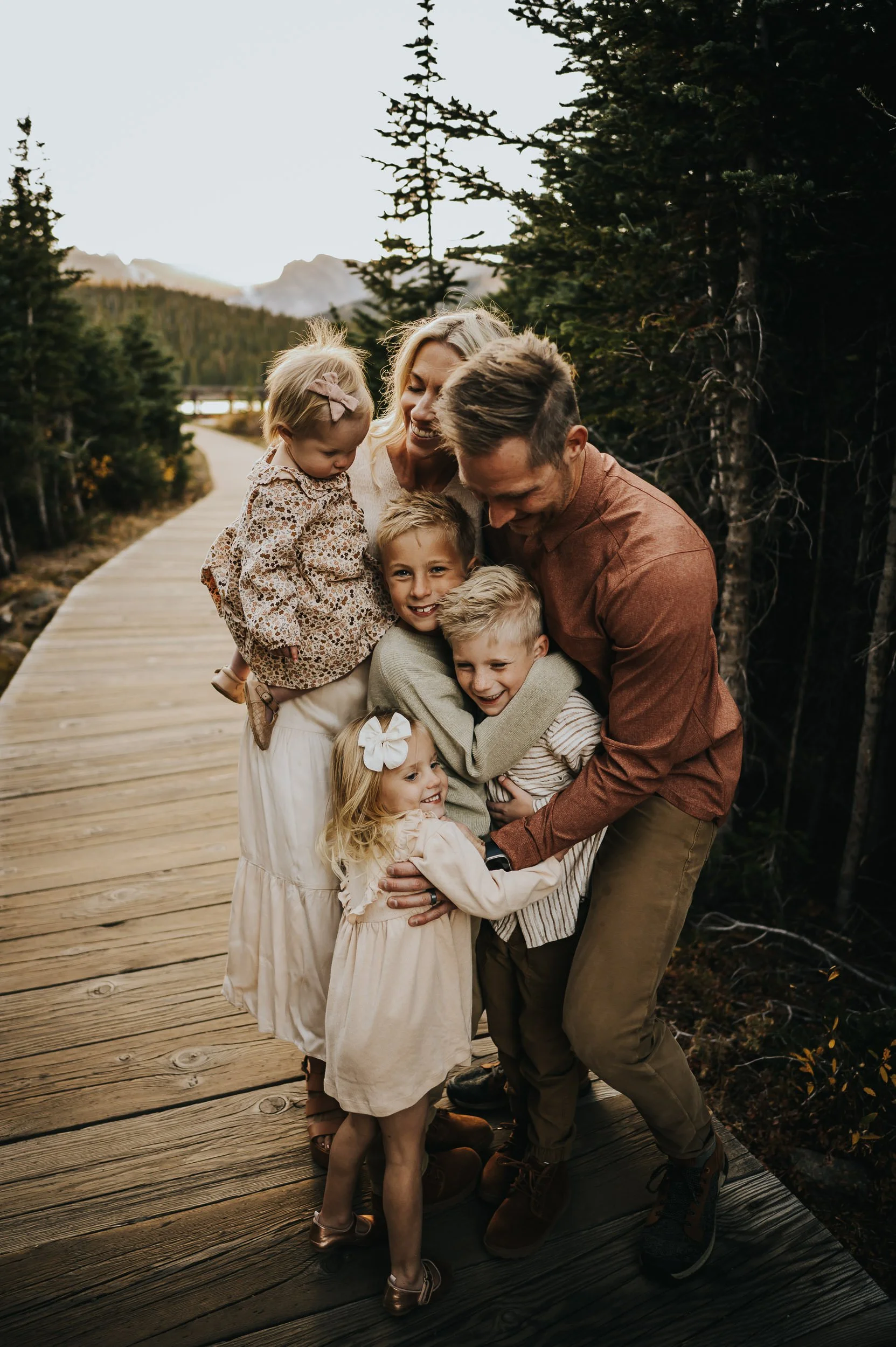 Mother walking hand in hand with her children during a family session at Brainard Lake.
