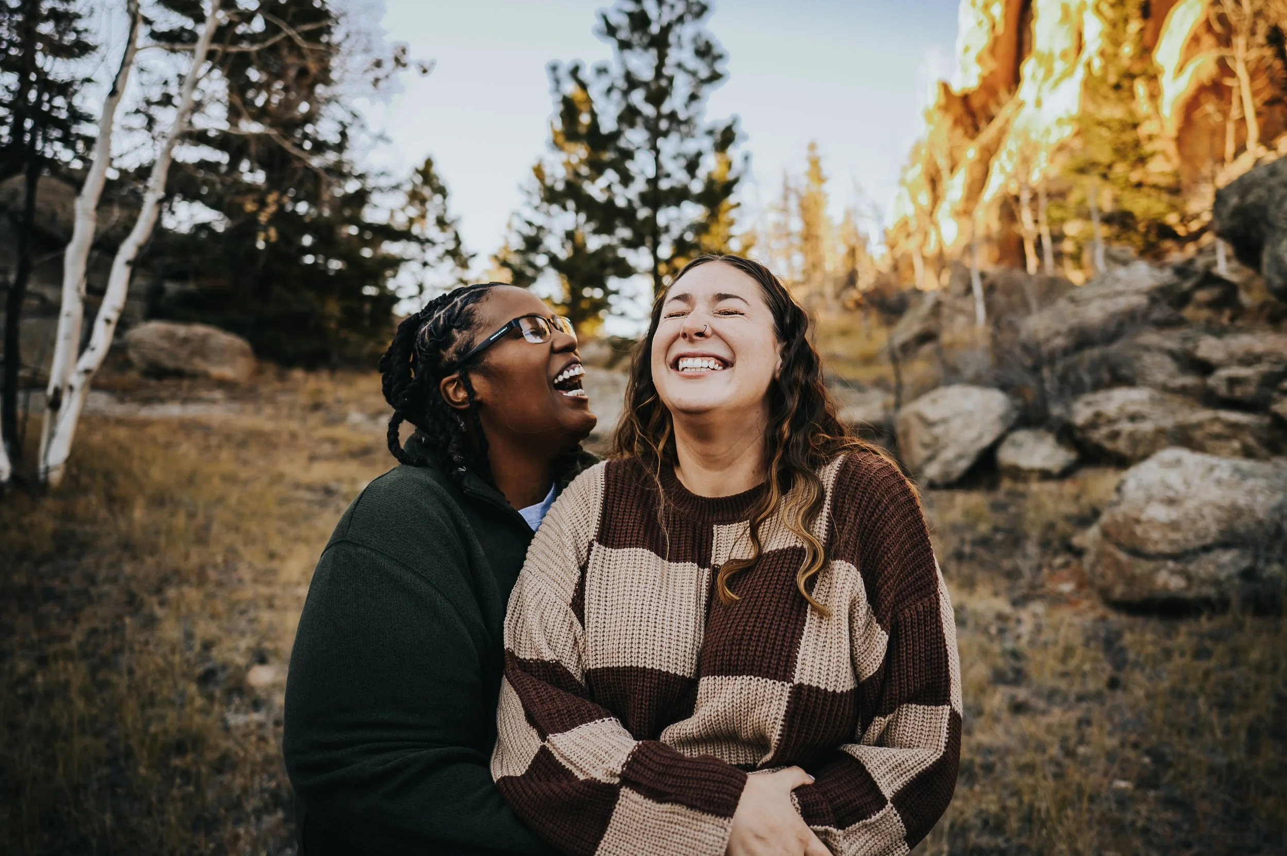 Couple laughing together in a mountain meadow near Lake George, Colorado.