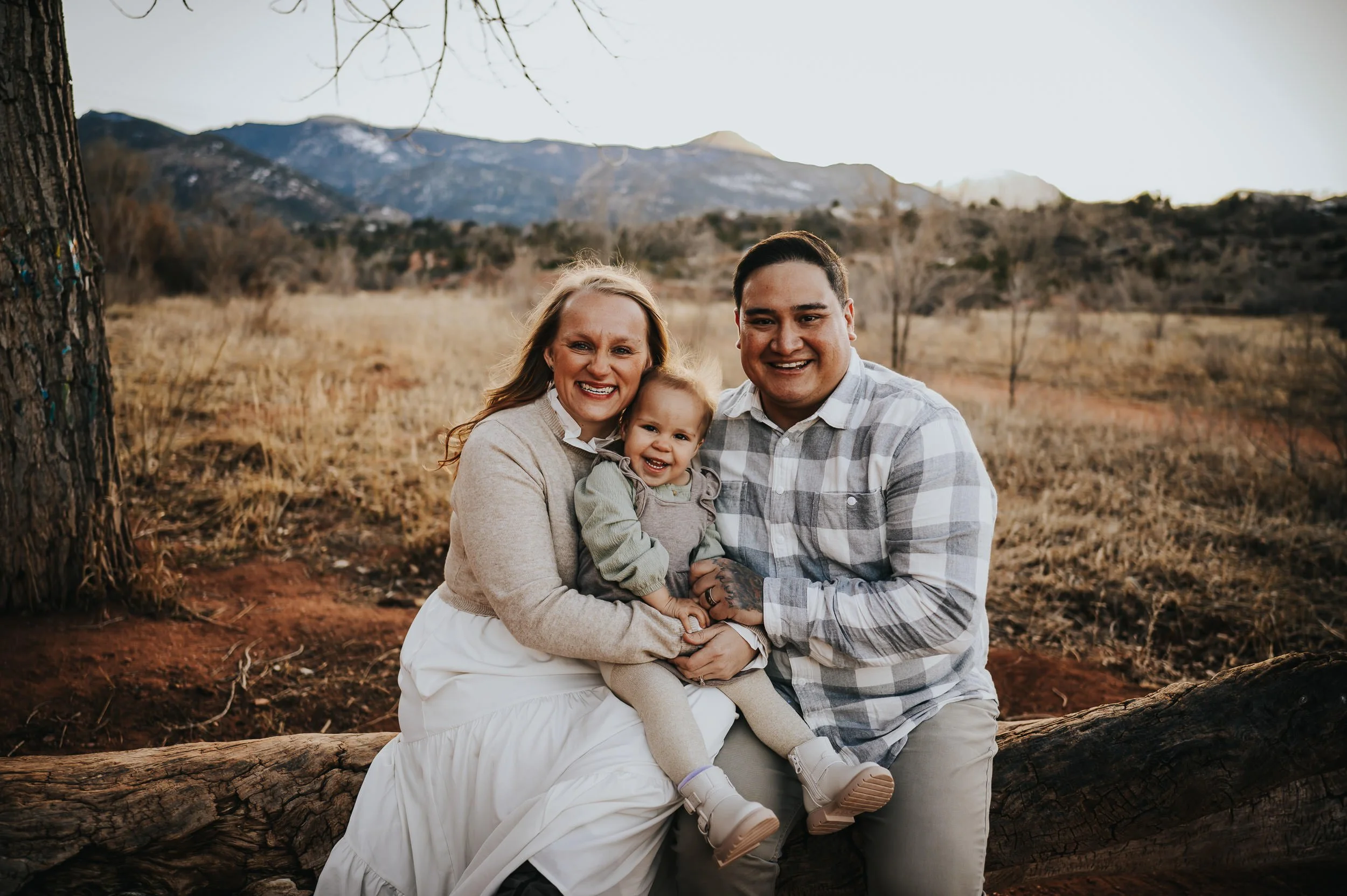 Family surrounded by warm golden light during sunset at Red Rock Canyon Open Space.