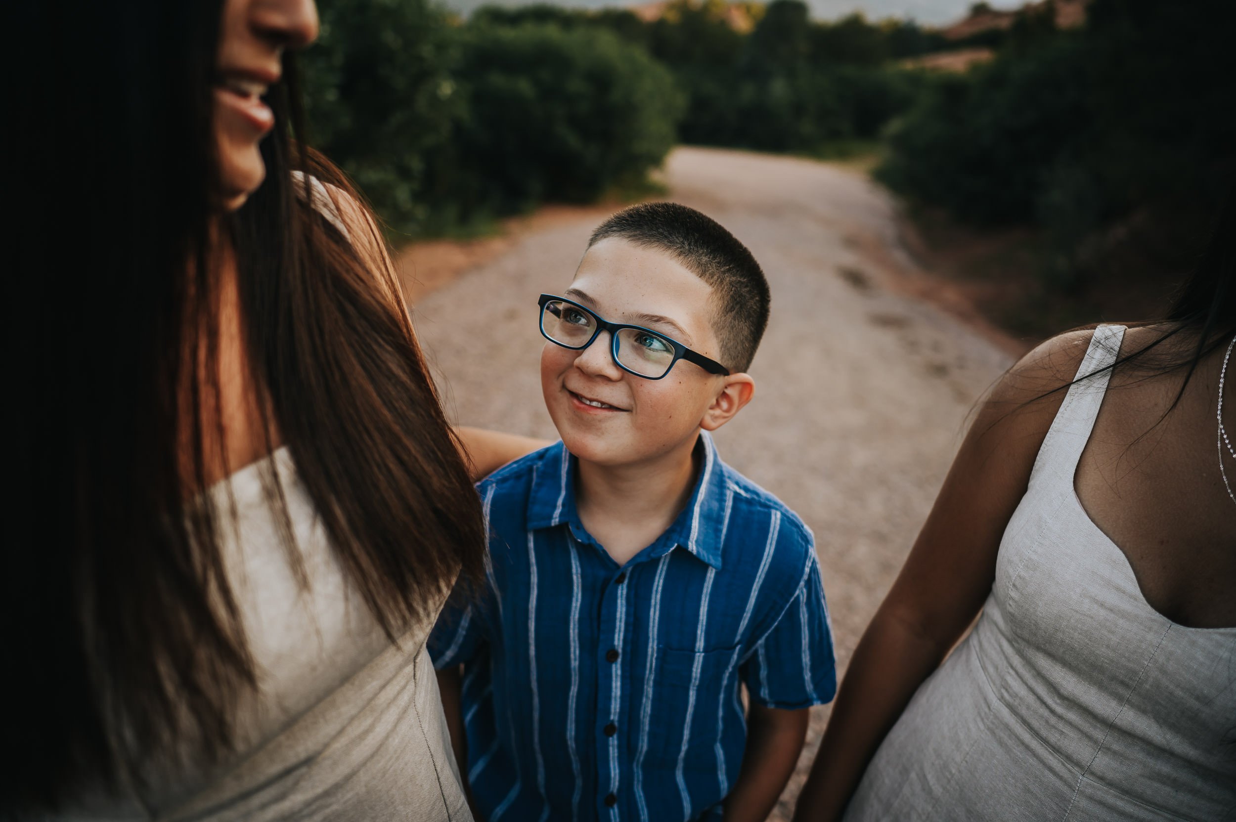 Kids smiling at their parents at Garden of the Gods during golden hour.
