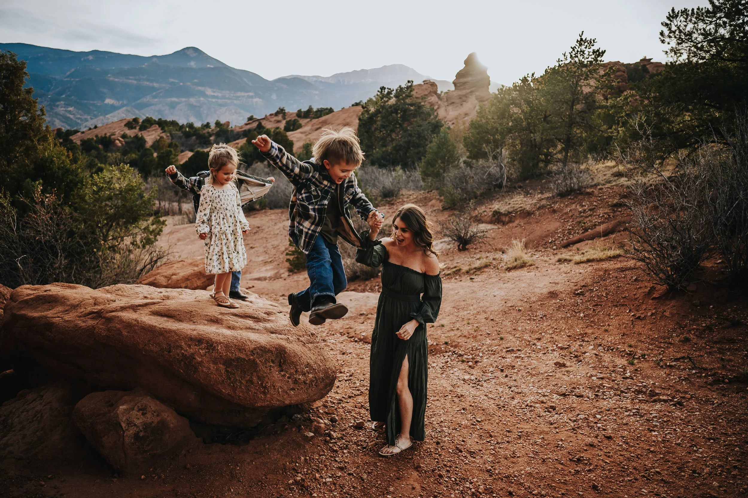 Kids jumping and playing while mom watches, candid movement.