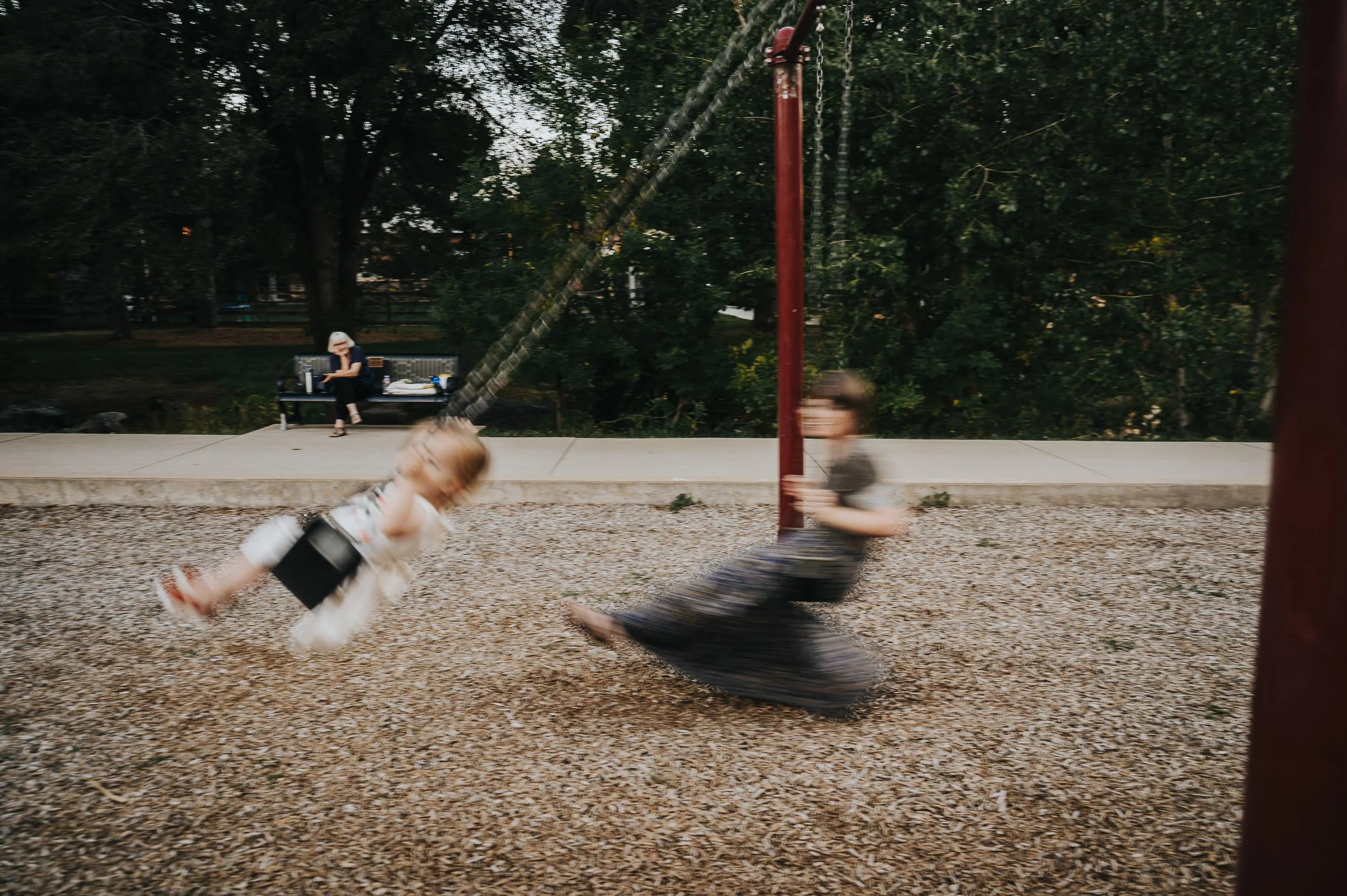 Mom swinging with her toddler during a relaxed family photography session in Denver.