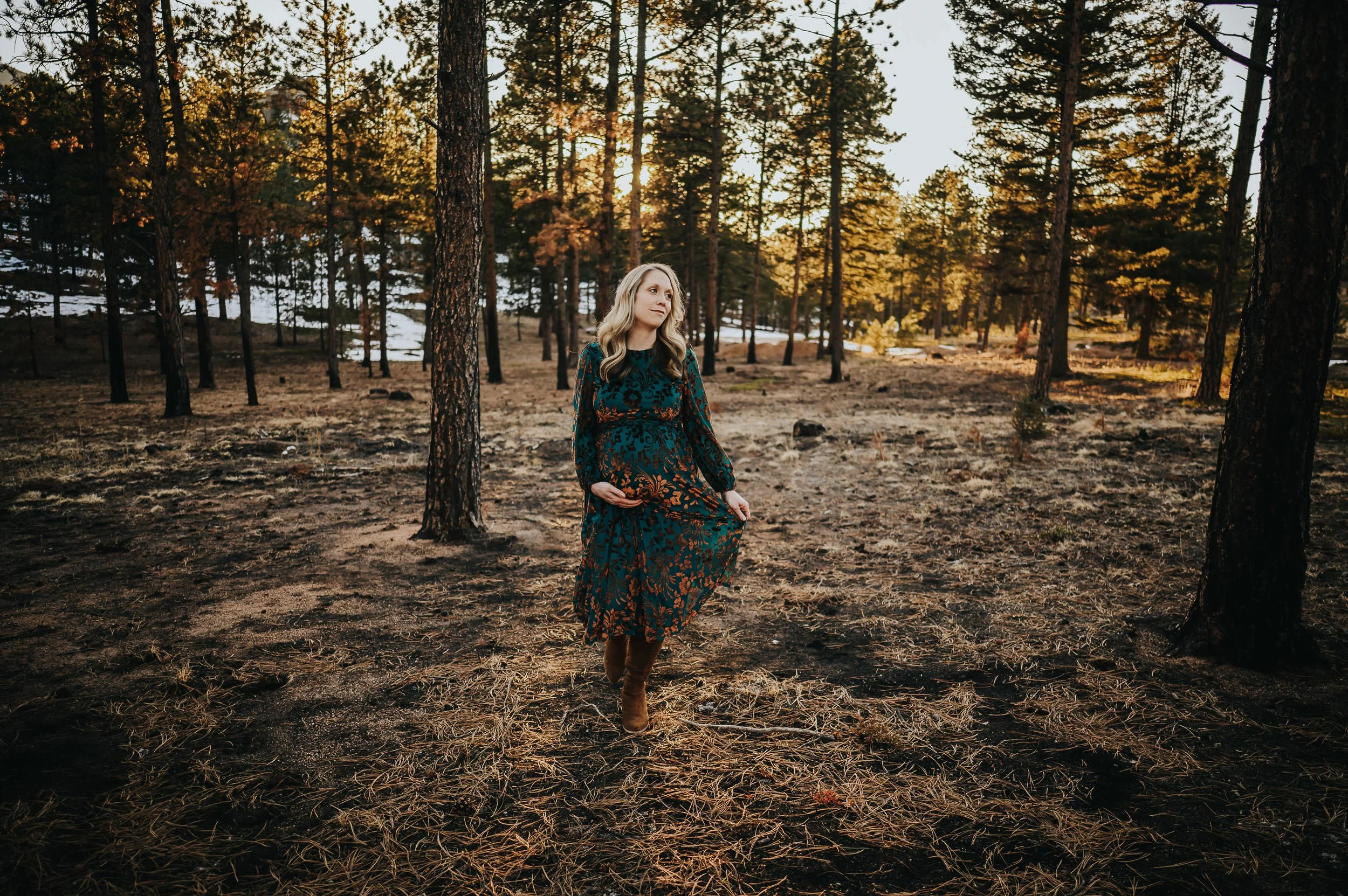 Sunlit maternity photography session captured outdoors in Colorado