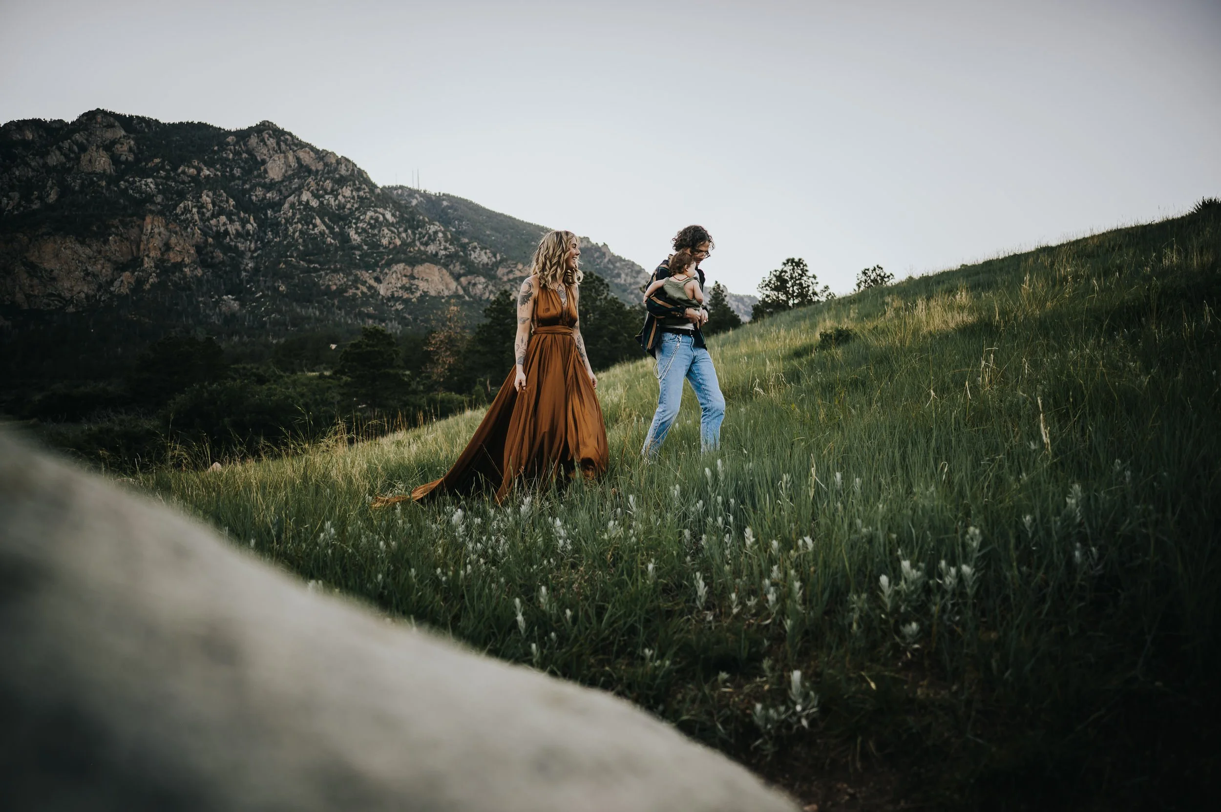 Parents walking with their toddler during an outdoor family photography session