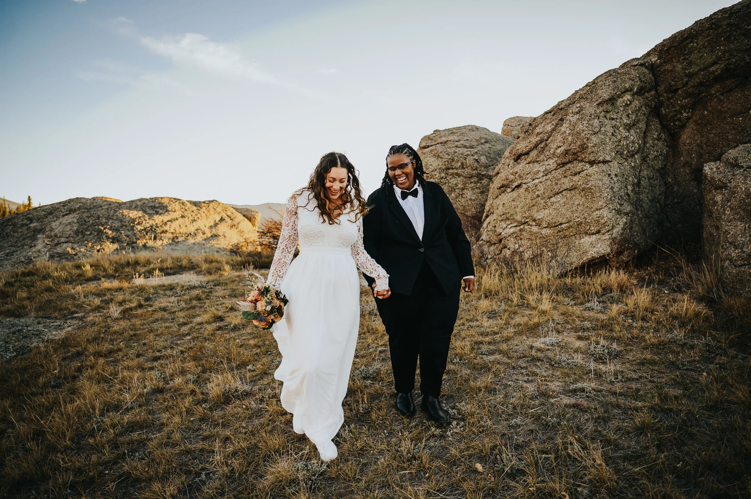 Bride emerging in wedding attire for her Colorado mountain elopement.
