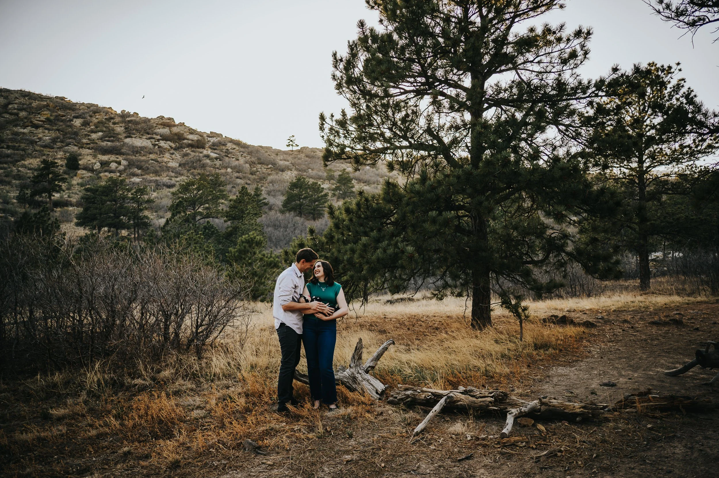 Parents with their newborn daughter during outdoor session at Ute Valley Park.