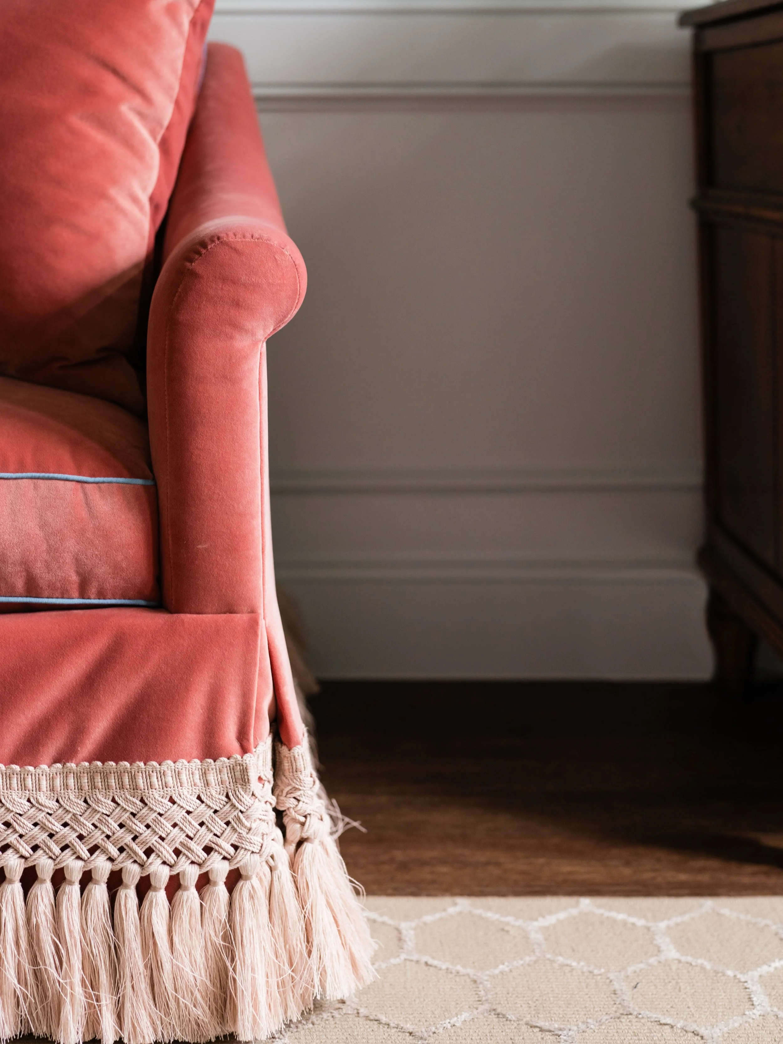 Luxury is rarely visible from across the room.

It lives closer &mdash; in the weight of a fabric against a cushion, the trim on a hem, the decision to let a pattern repeat across two surfaces until the room stops competing with itself.

These are th