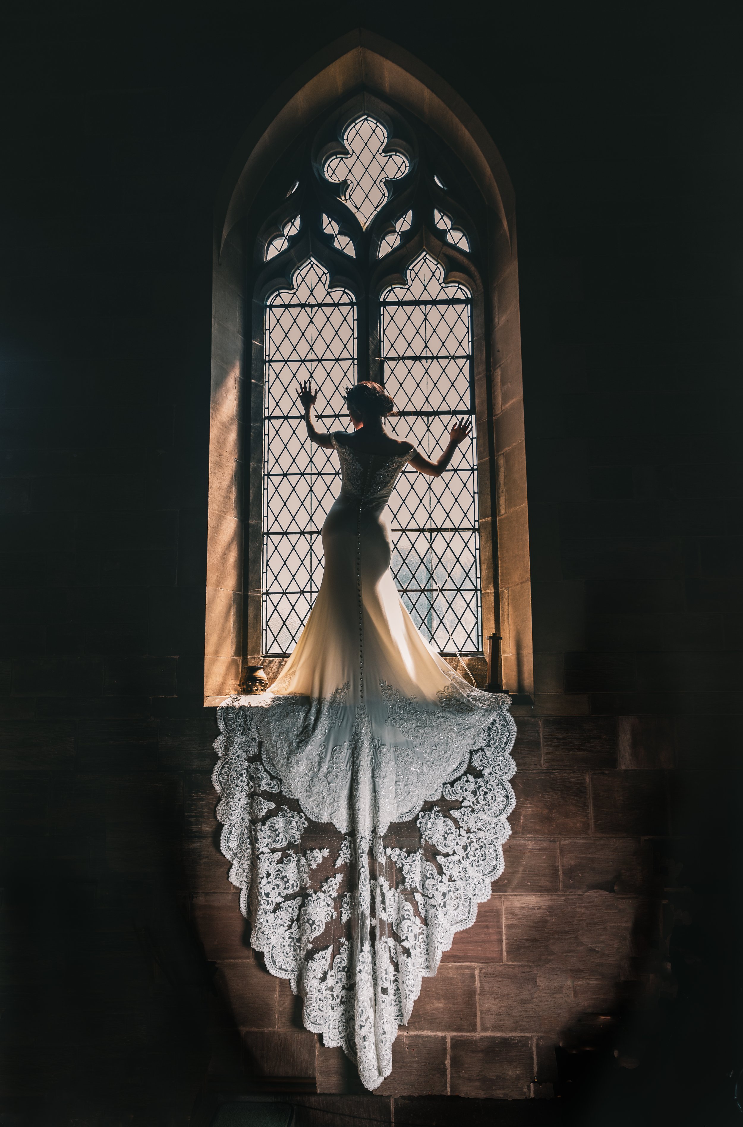 Wedding photography of bride posing in the window