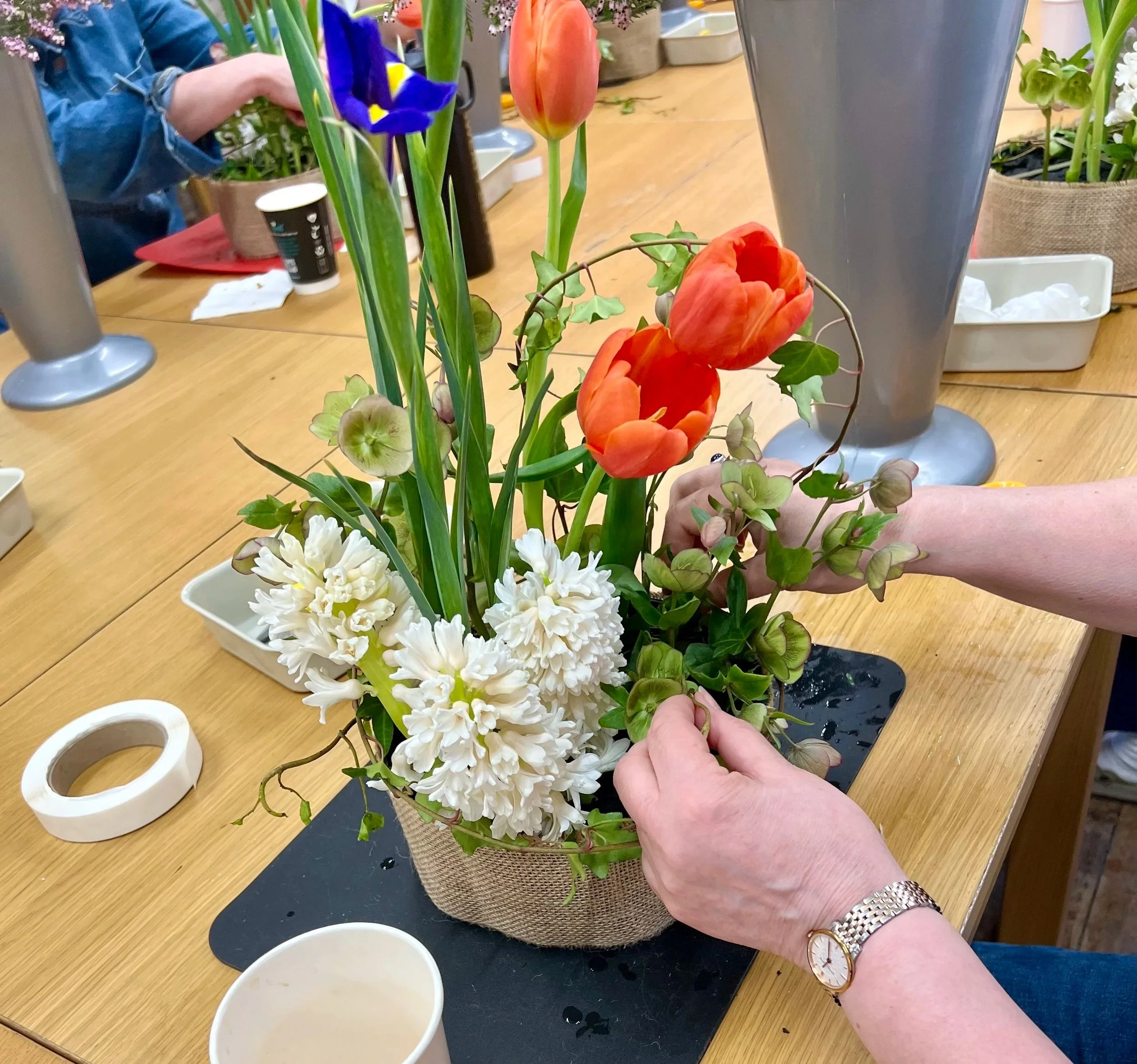 Spring vegetative floral design with iris, tulips and hyacinth