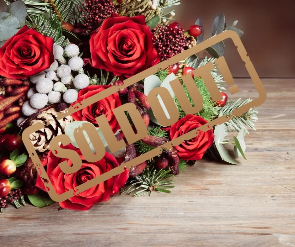 a Christmas flower bouquet including red roses
