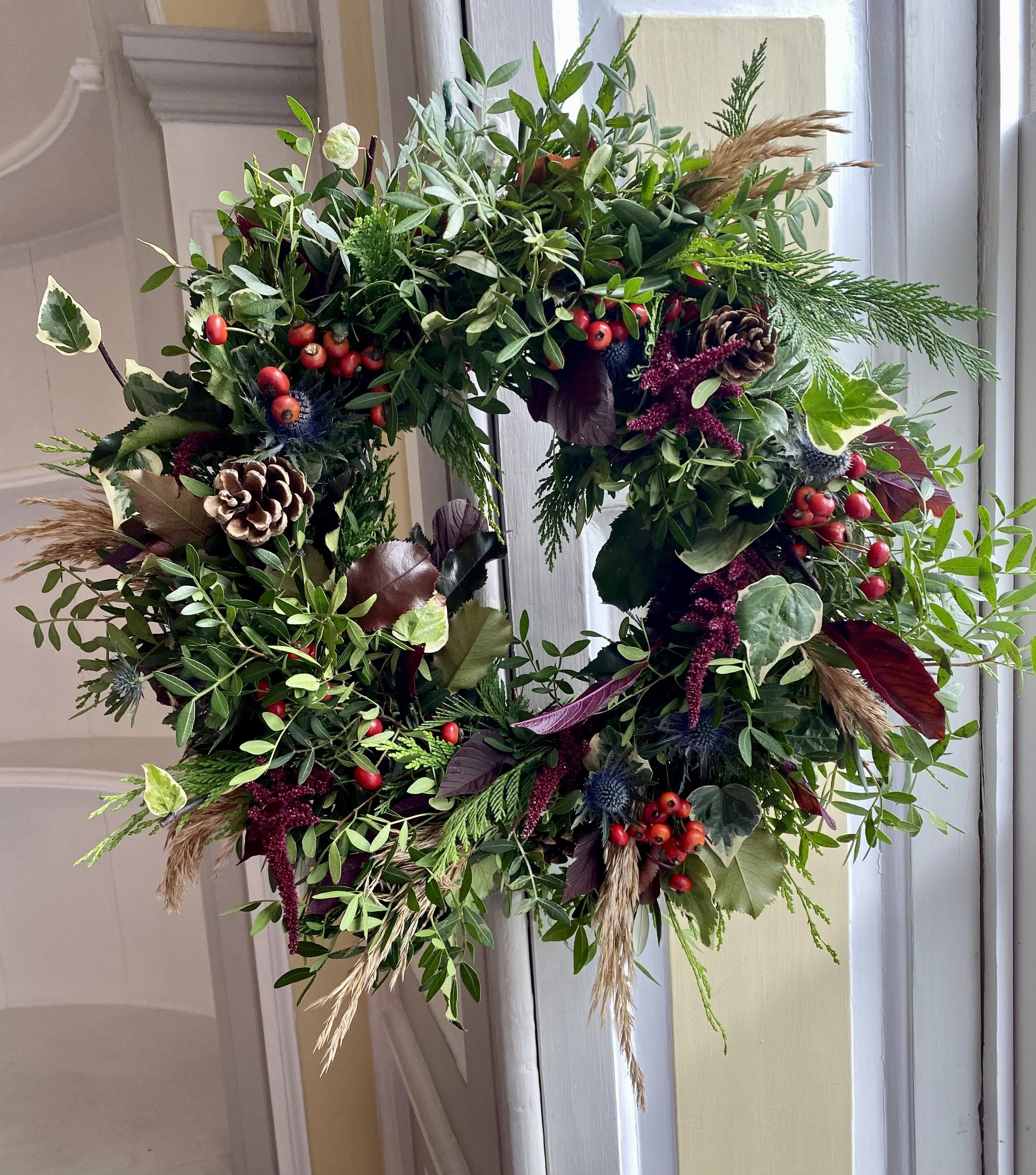 Autumn Wreath Workshops using seasonal foliage in autumnal colours with dried elements and fresh berries.