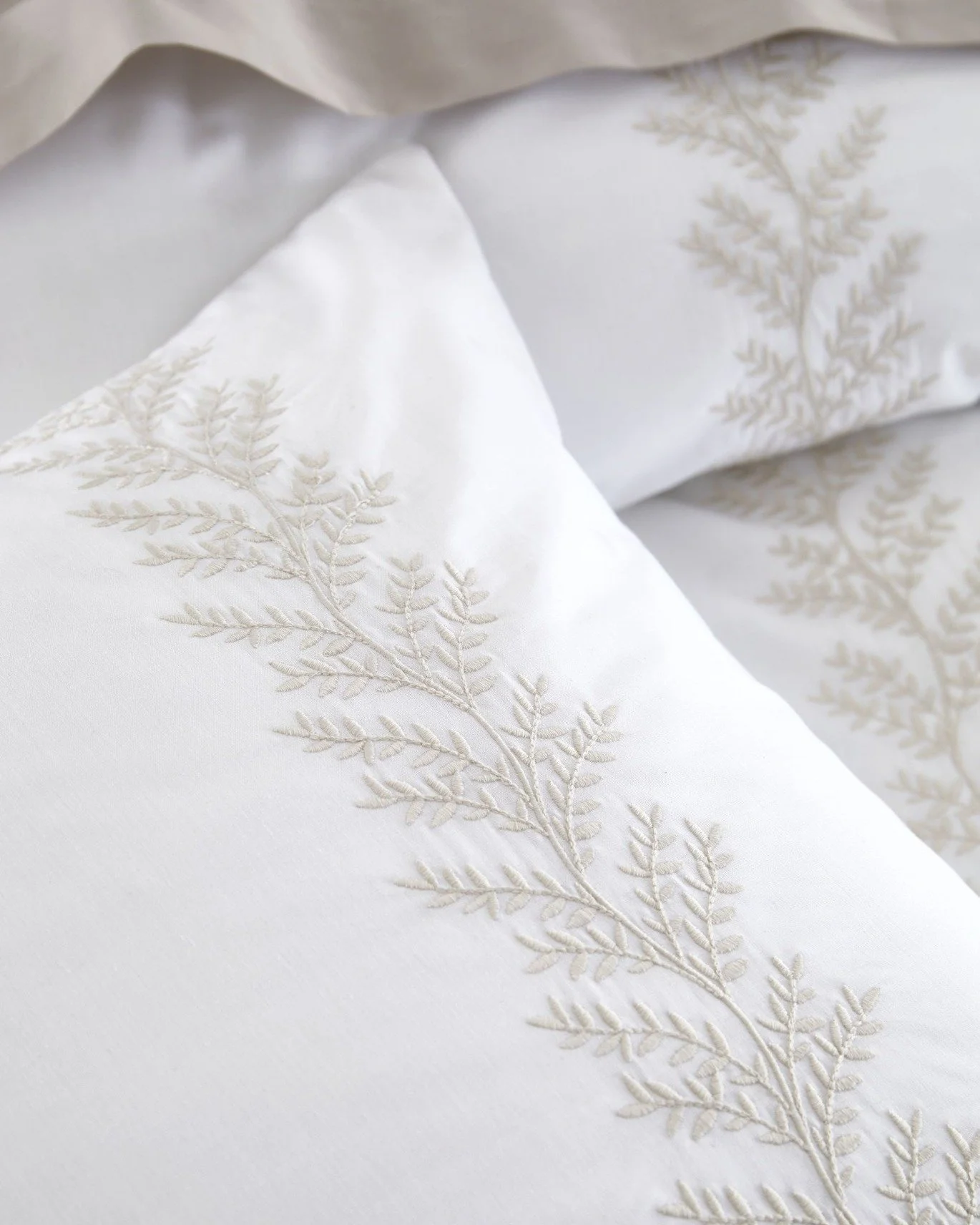 Delicate embroidered leaf motifs flow softly across crisp white cotton, bringing nature-inspired elegance to your bedroom. 🍃
Refined and calming, this design blends subtle detailing with timeless simplicity.

#BiancaFineLinens #EmbroideredElegance #