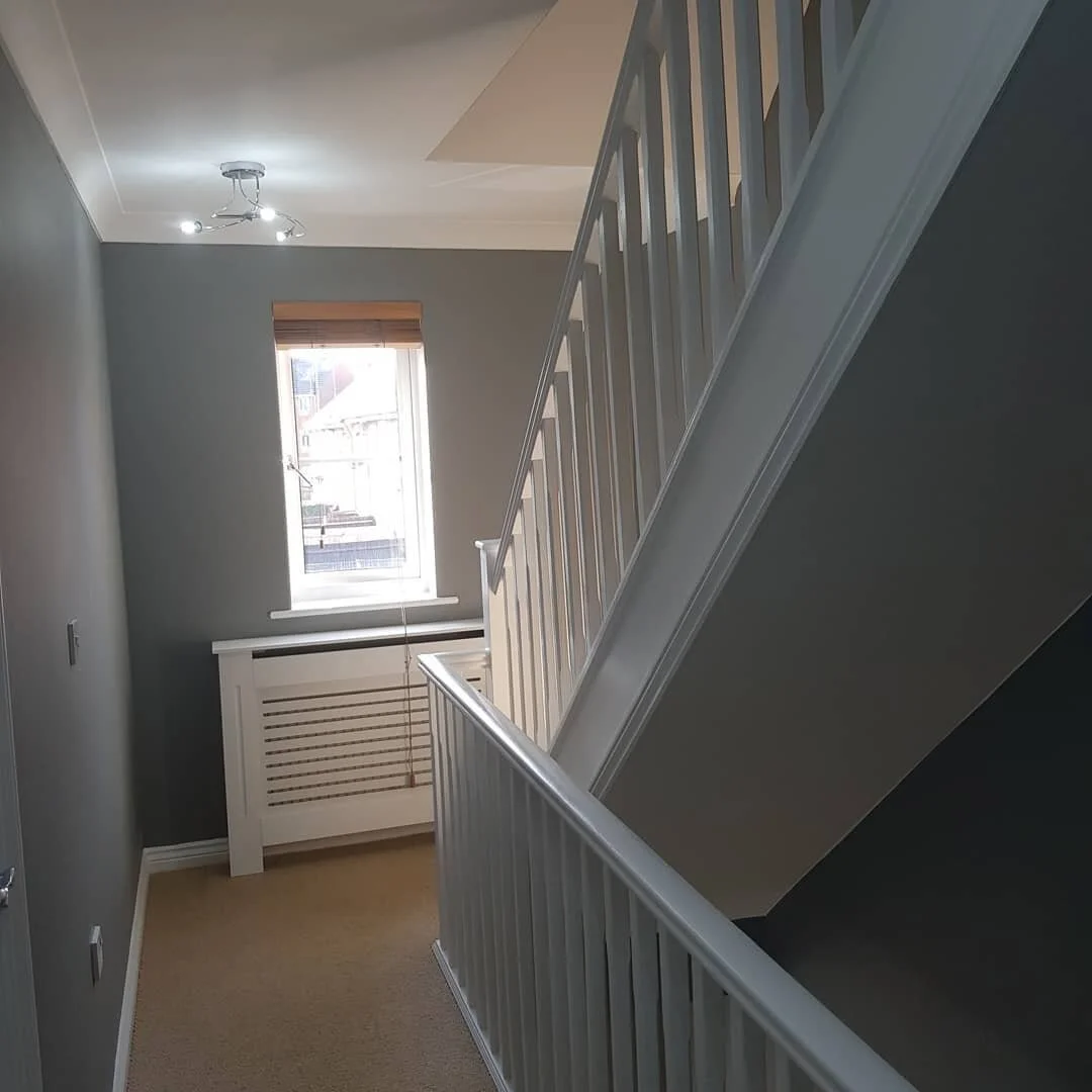Hall stairs and landing looks bigger.....
Ascending this fine town house staircase was a rather beige experience. 

Thanks to Little Greene Grey Teal the fine white woodwork and radiator covers offer a colour contrast that makes the space more spacio
