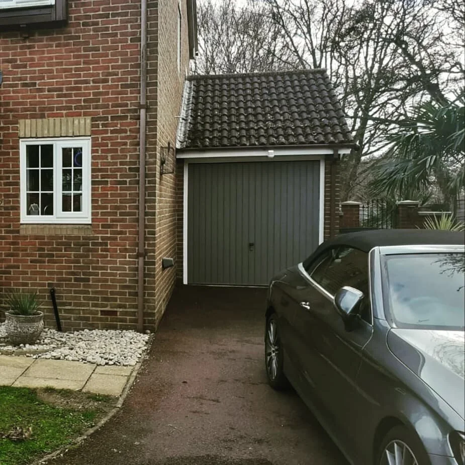 When you colour match your car with its garage door ......
This elegant convertible Mercedes sits pride of place on the driveway now the garage door has been restored and colour matched. 

Little Greene Dark Lead looks great here, with colour matched