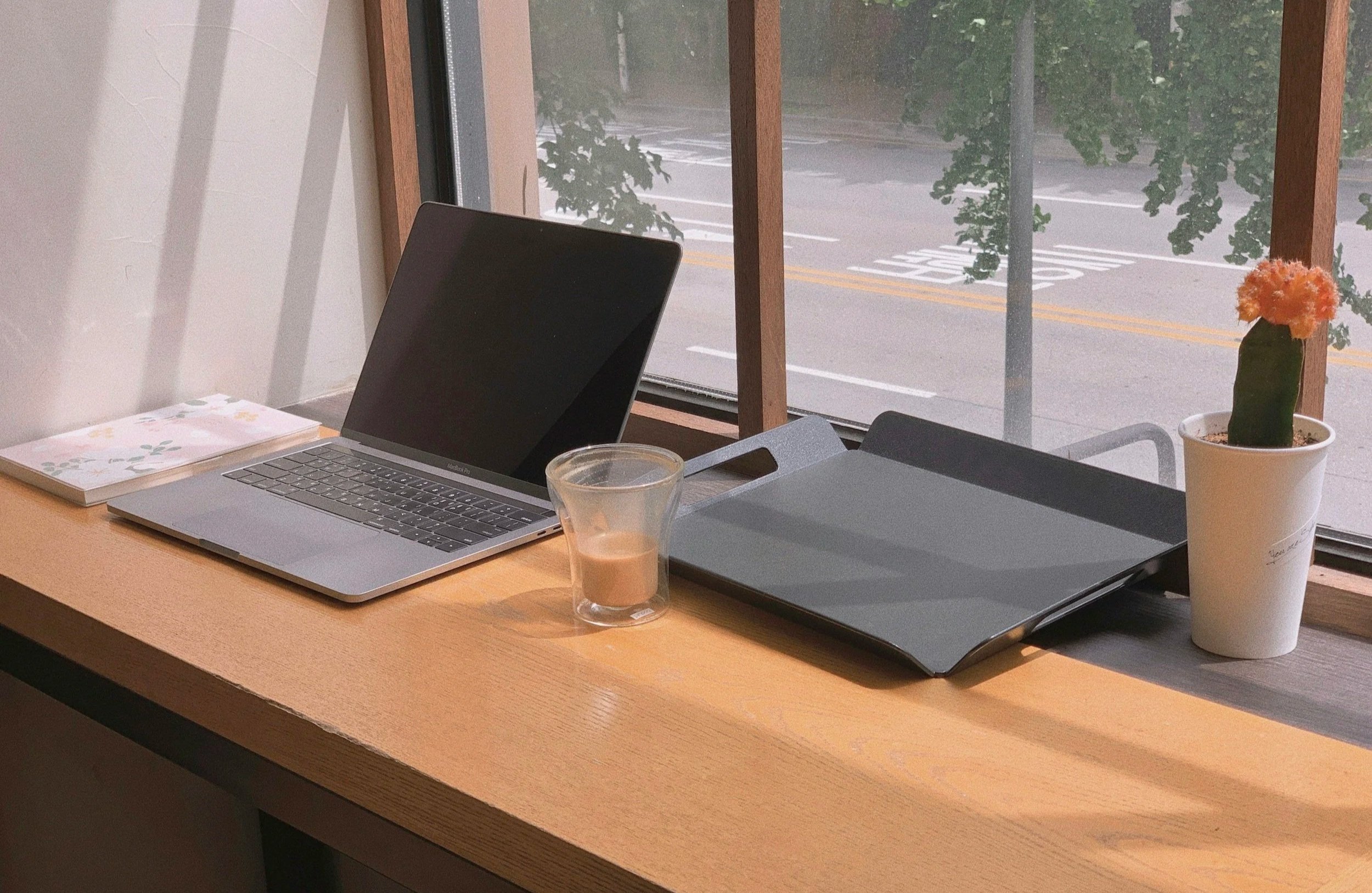 Laptop and coffee on desk in professional office setting for marketing