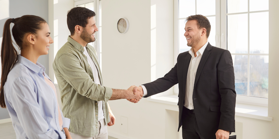 Property manager closing a rental lease signing with tenants after using automated follow-up email marketing to fill vacancies faster