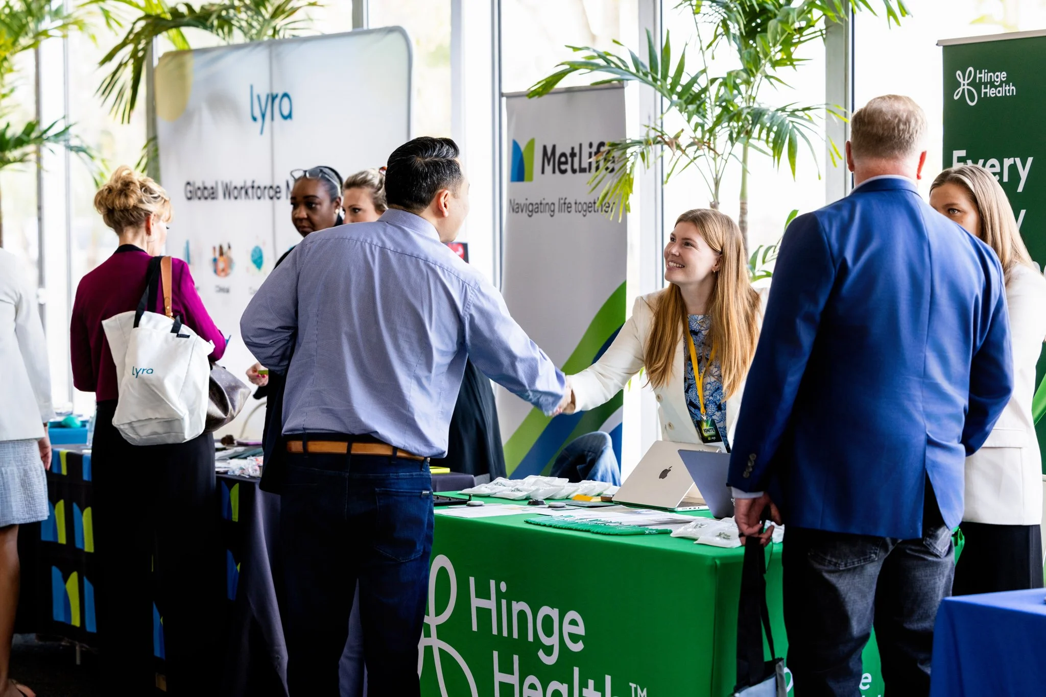 Candid photo of vendors chatting with attendees at a corporate seminar