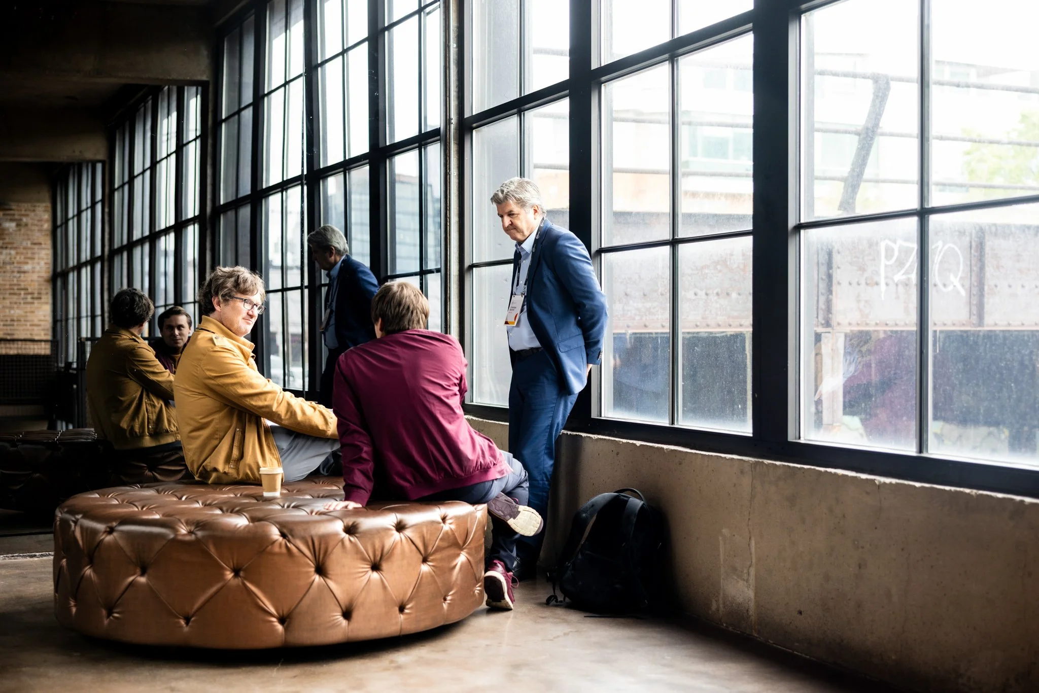 Candid shot of guests mingling at corporate seminar during downtime