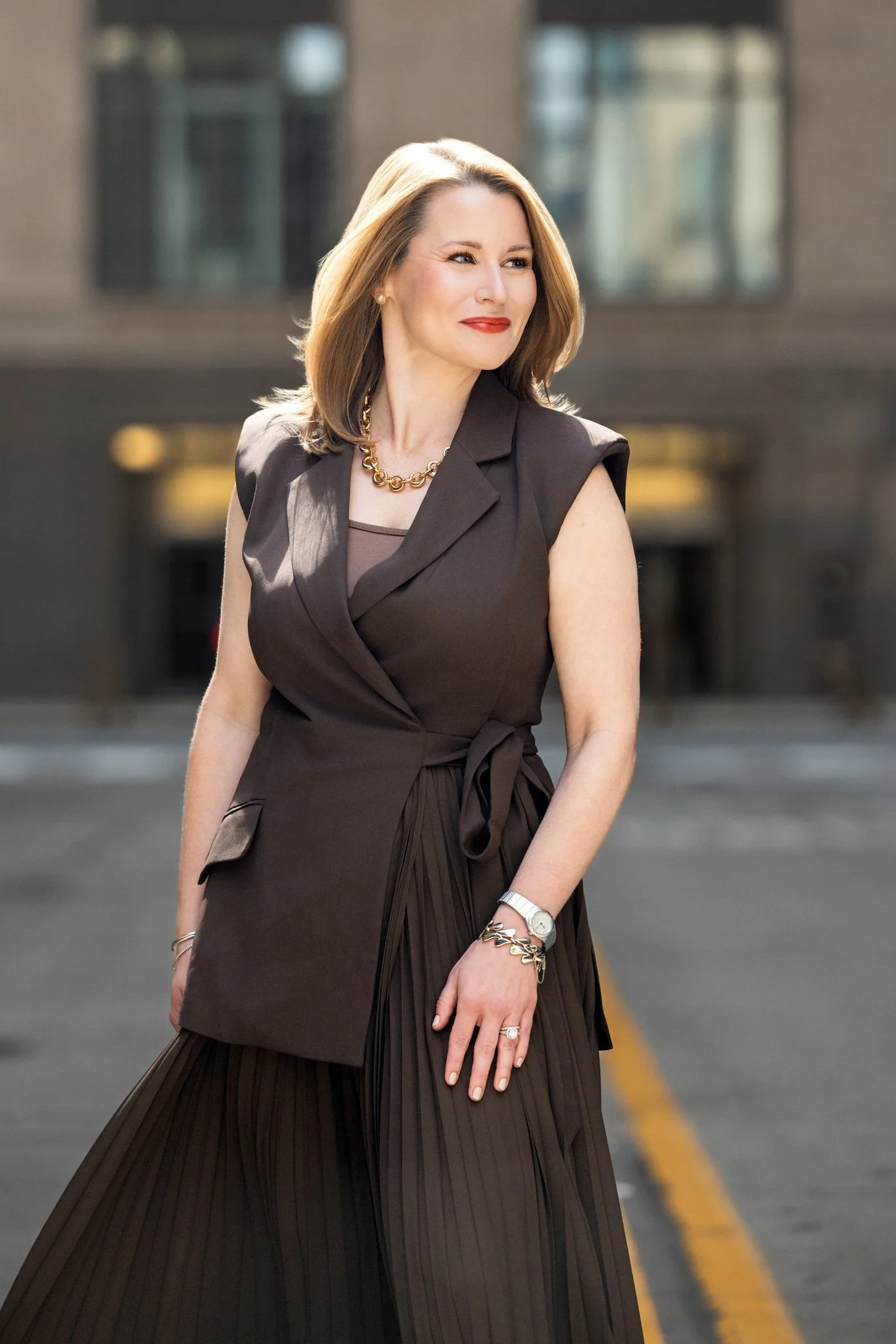 Environmental headshot on downtown Chicago street of woman in brown