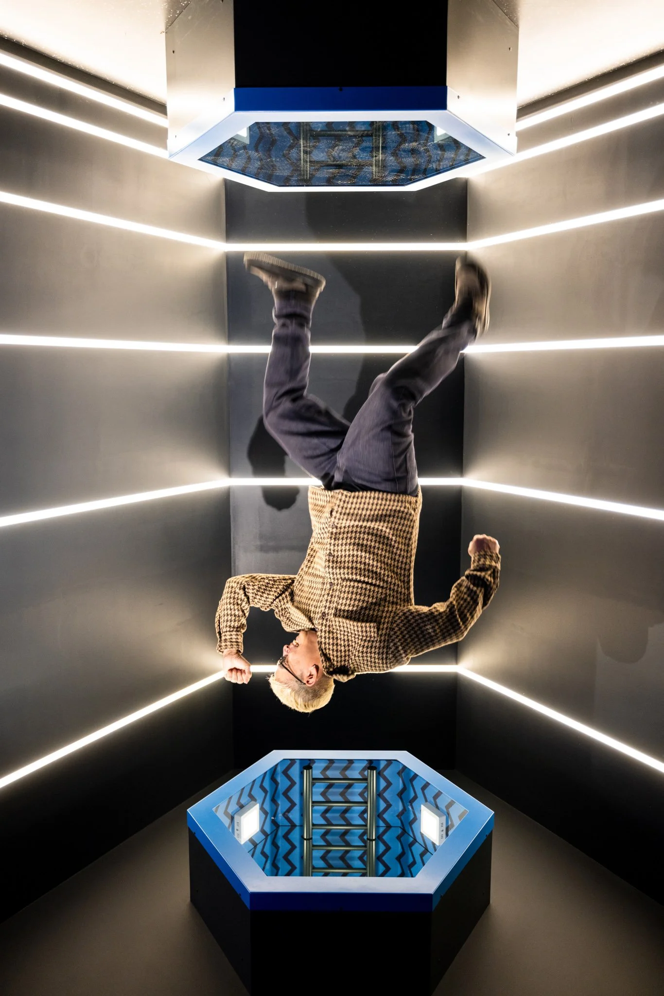 Illusion of man upside at exhibit at Museum of Illusions