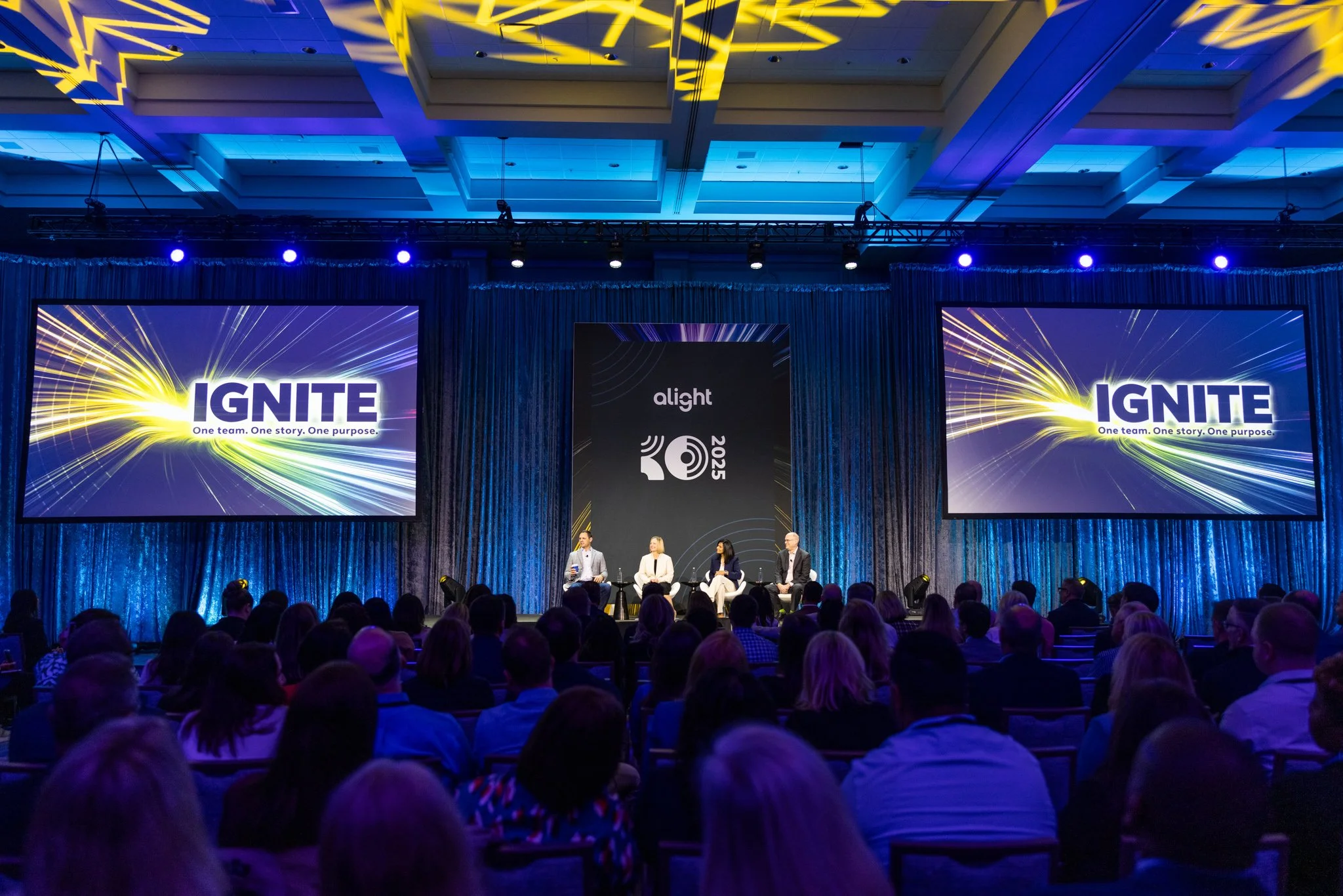 Wide photo of conference room washed in blue light at the Ignite conference in Chicago